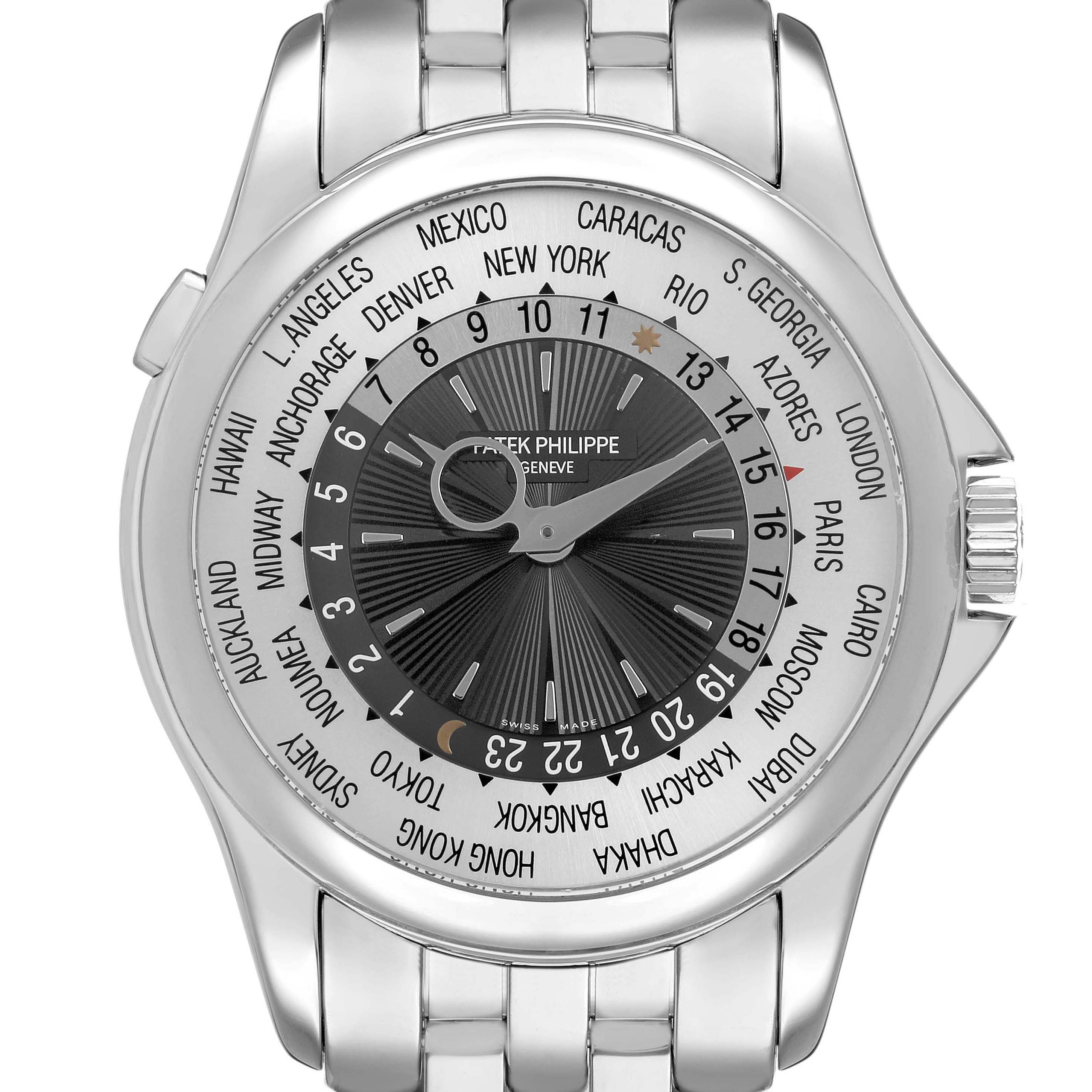 The Patek Philippe Complications 5130/1G-010 Mens White Gold Black Dial watch is shown from a front angle, highlighting its dial, bezel, and bracelet.