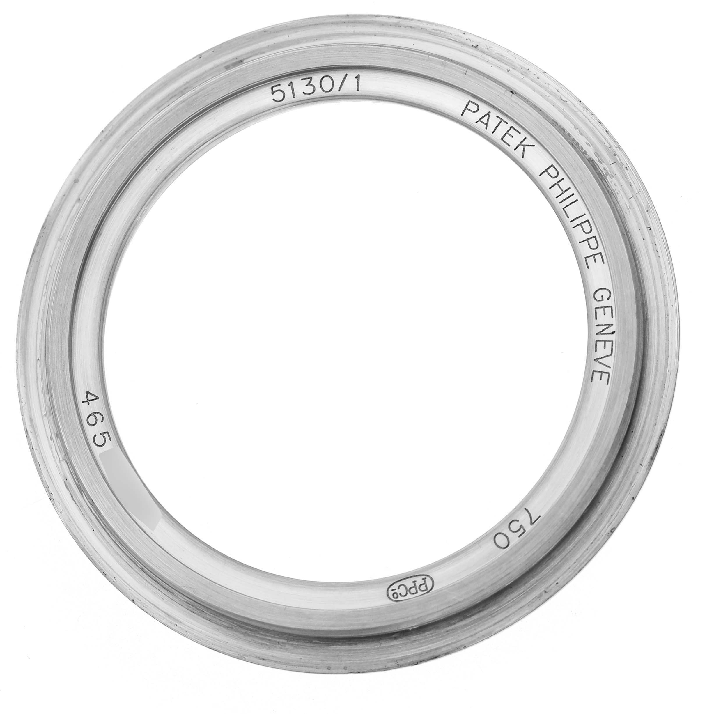 This is a top view of the bezel for a Patek Philippe Complications 5130/1G-010 Men's White Gold Black Dial model, showing engravings and metal finish.