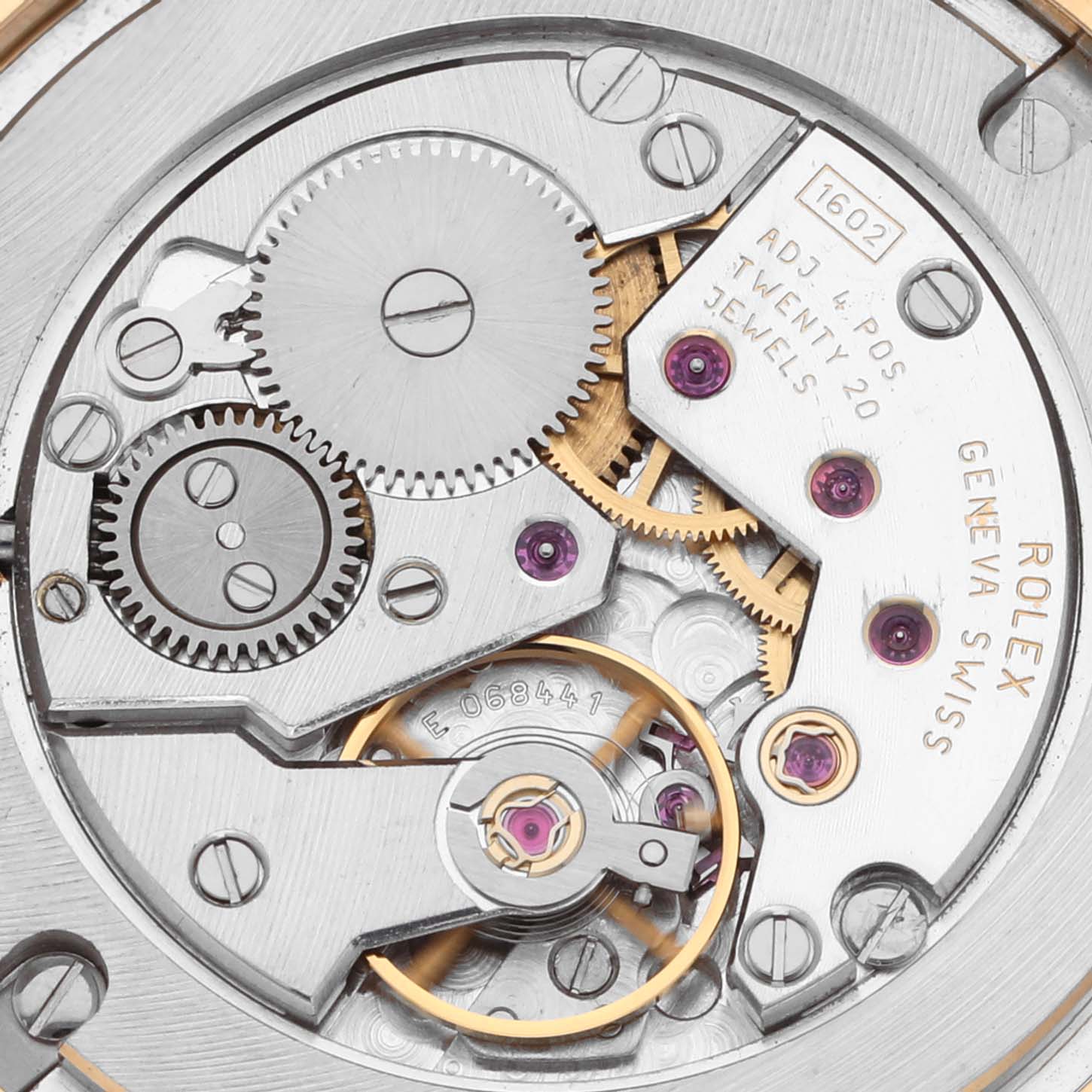 The image shows the movement mechanism of a Rolex Cellini 5115 Men's Yellow Gold Beige Dial 5115 Men's Yellow Gold Beige Dial watch from a top-down angle, highlighting gears and jewels.