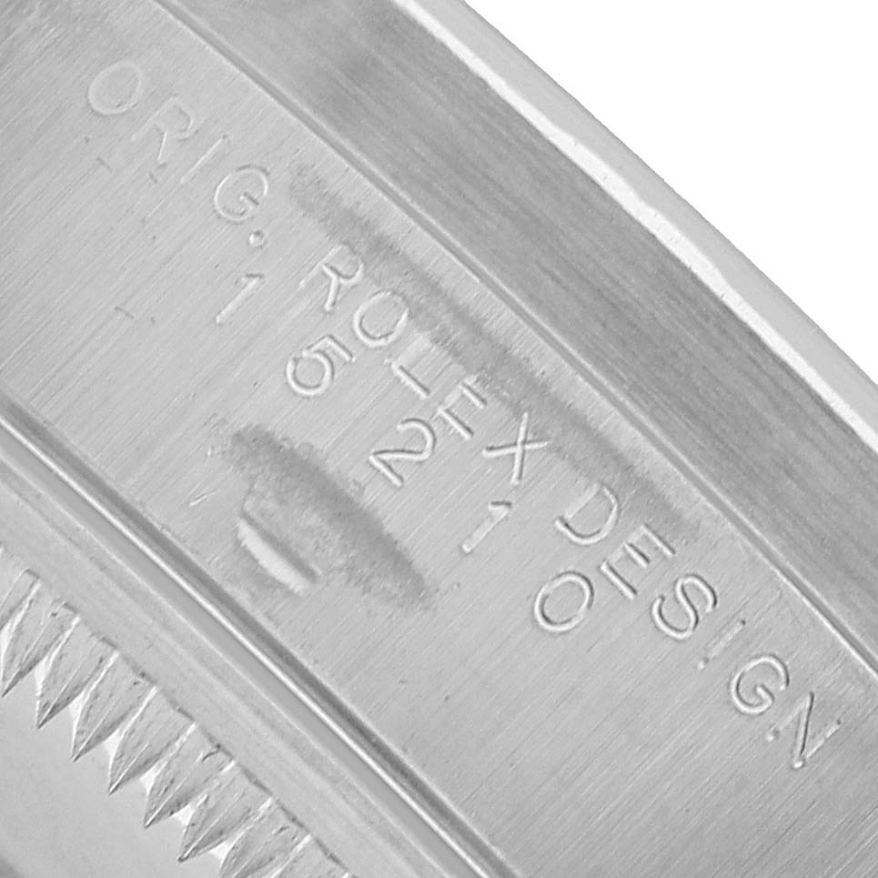 The image shows the inner case engraving of a Rolex Date 15210 Men's Stainless Steel White Dial model, highlighting the "ORIG ROLEX DESIGN" inscription with a partial view of the teeth for the bezel.