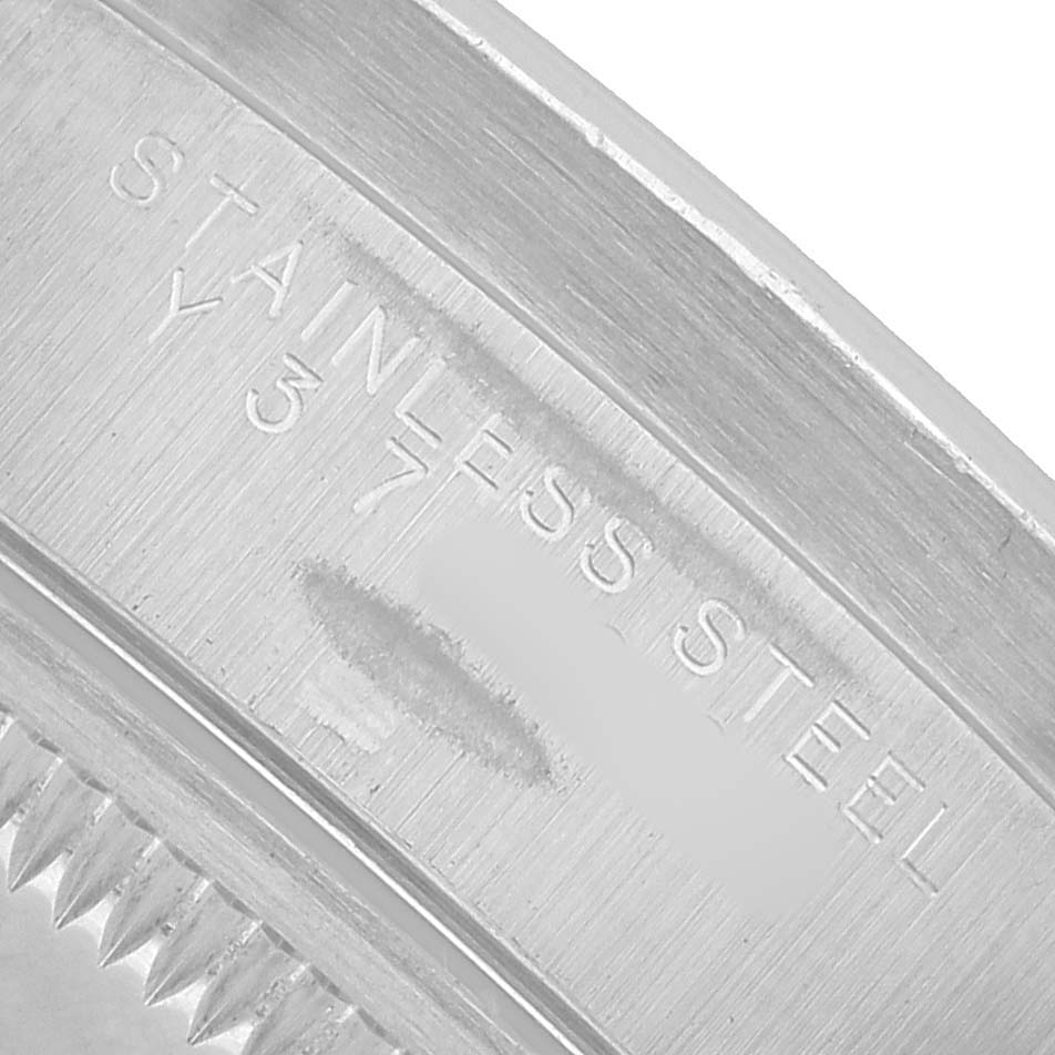 The image shows a close-up angle of the inner bezel with "Stainless Steel" engraving on the Rolex Date 15210 Men's Stainless Steel White Dial model.