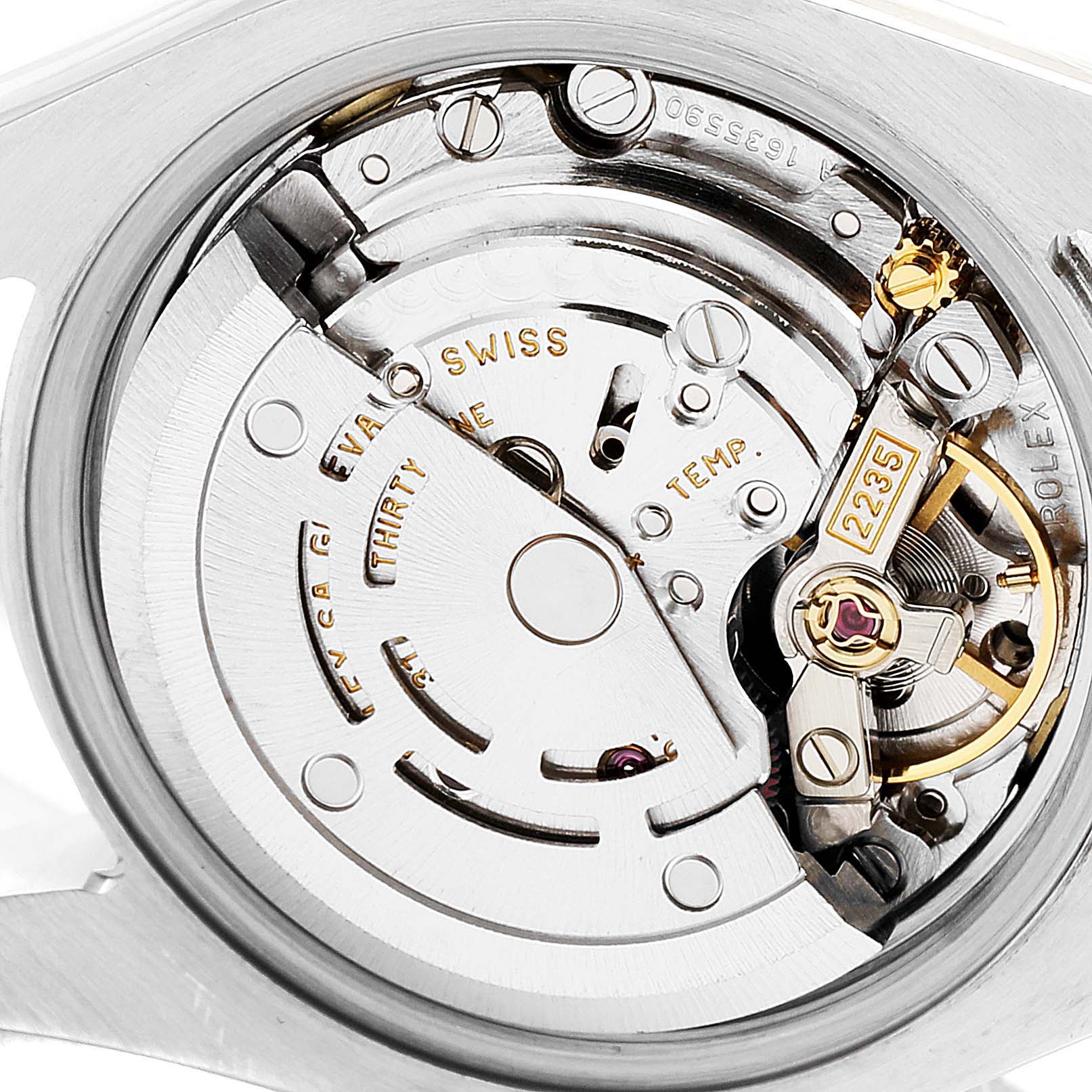 The image shows a close-up view of the Rolex Datejust 179173 Women's Steel and Gold (two tone) Champagne Dial 179173 Women's Steel and Gold (two tone) Champagne Dial's movement and intricate internal mechanism.