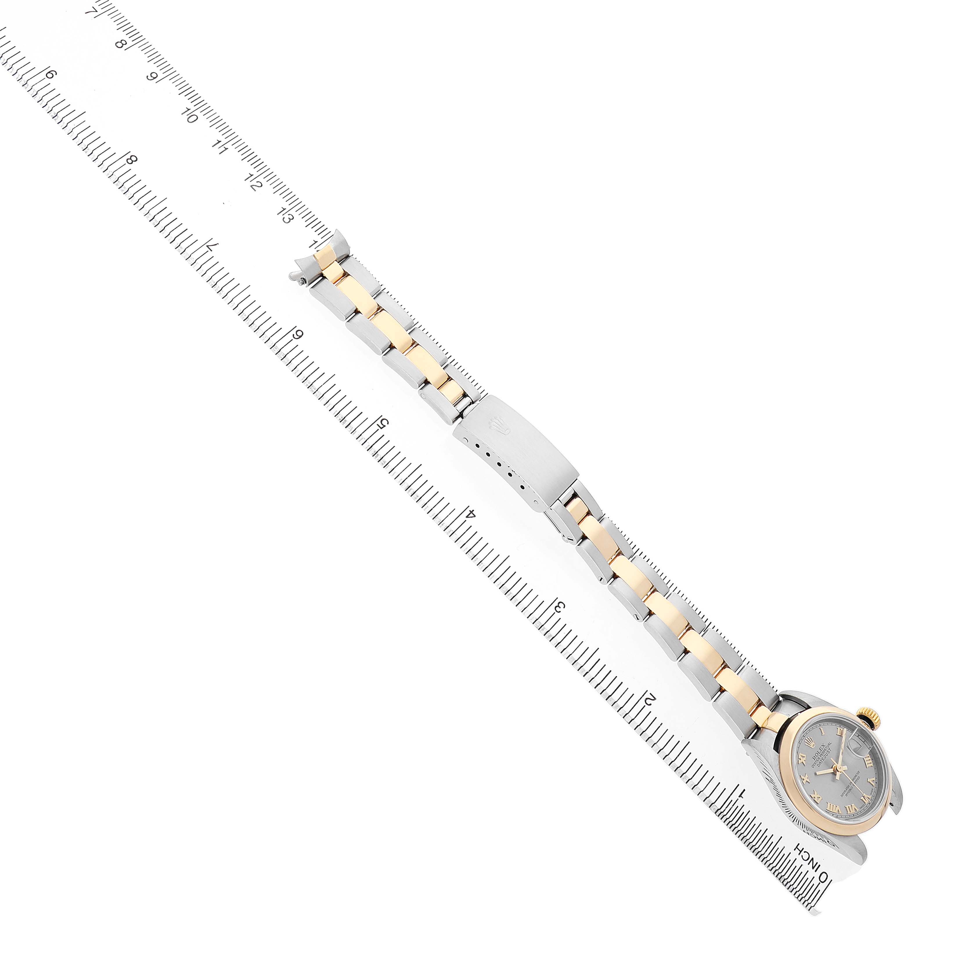 The Rolex Datejust 79163 Women's Steel and Gold (two tone) Grey Dial watch is shown from an overhead angle, featuring its bracelet and bezel alongside a ruler for scale.