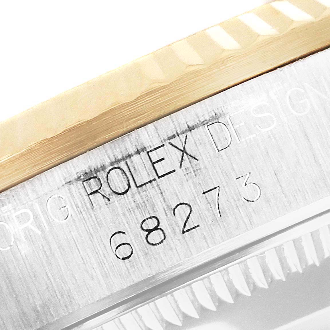 The image shows a close-up of the case side of a Rolex Mid-Size 68273 Women
s Steel and Gold (two tone) White Dial 68273 Women
s Steel and Gold (two tone) White Dial model 68273, with the model number engraved.