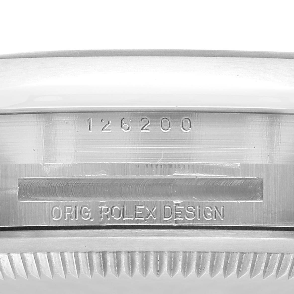 The image shows a close-up of the serial and model number engraving on the side of a Rolex Datejust 126200 Men's Stainless Steel Blue Dial 126200 Men's Stainless Steel Blue Dial watch case.
