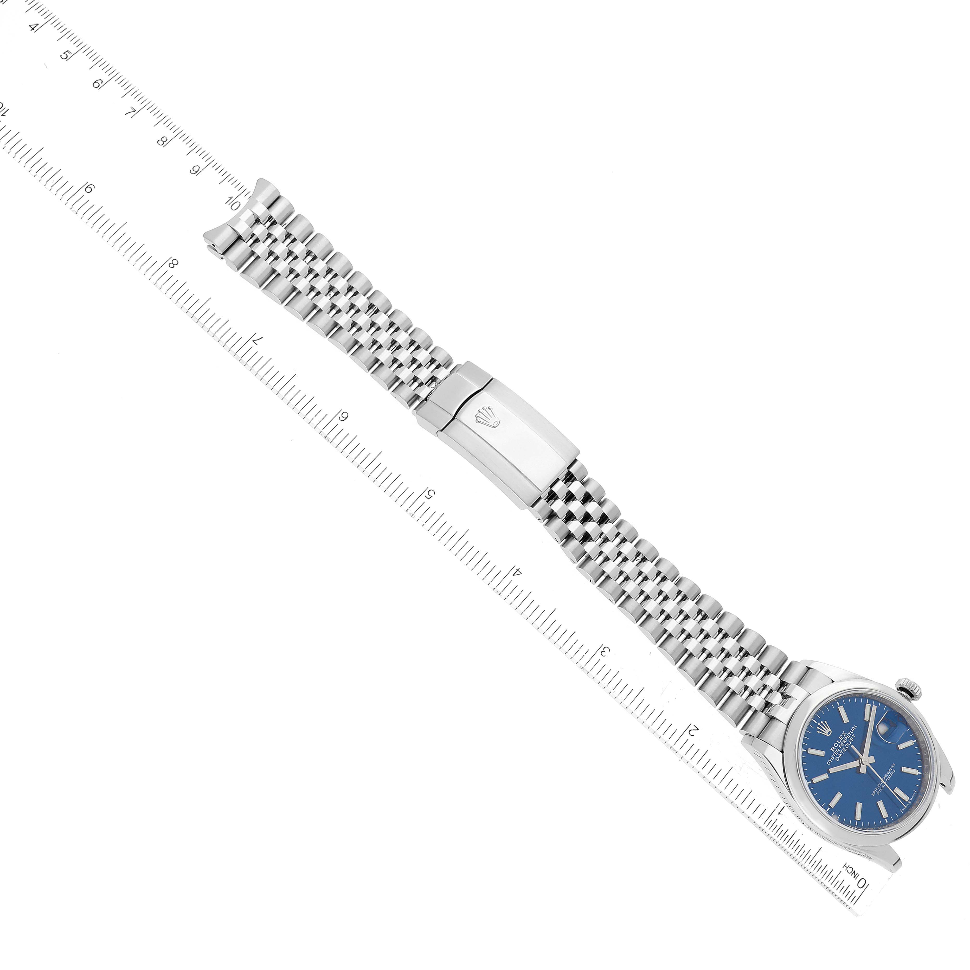 The image shows a top view of a Rolex Datejust 126200 Men's Stainless Steel Blue Dial 126200 Men's Stainless Steel Blue Dial watch, highlighting the blue dial and stainless steel jubilee bracelet with clasp.