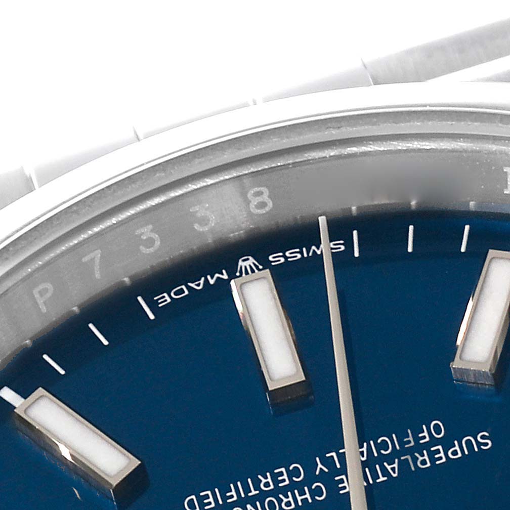 This image shows a close-up of the dial and part of the bezel of a Rolex Datejust 126200 Men's Stainless Steel Blue Dial 126200 Men's Stainless Steel Blue Dial watch.