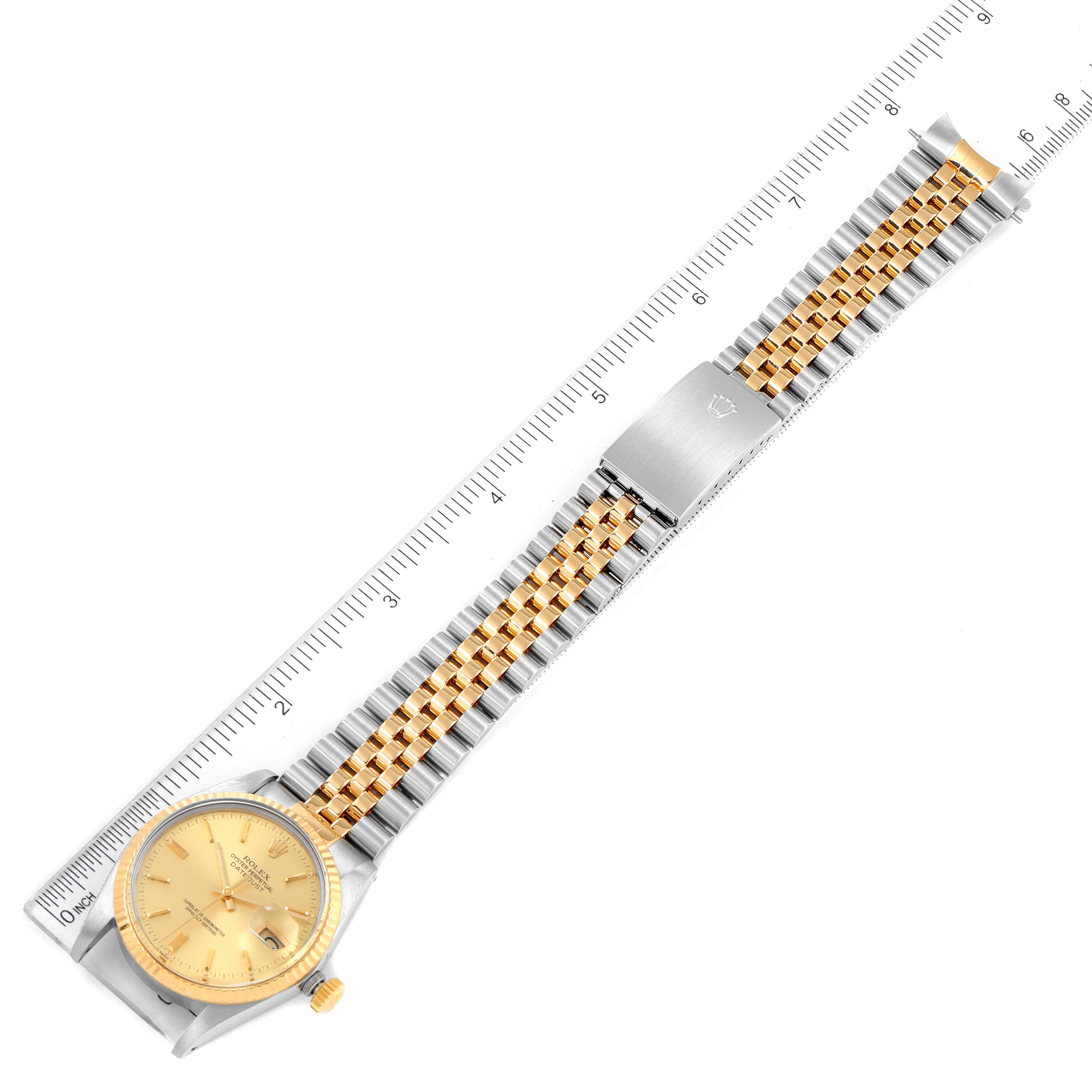 The image shows a Rolex Datejust 16013 Men's Steel and Gold (two tone) Champagne Dial 16013 Men's Steel and Gold (two tone) Champagne Dial watch laid flat with the dial, bracelet, and clasp visible, alongside a ruler.