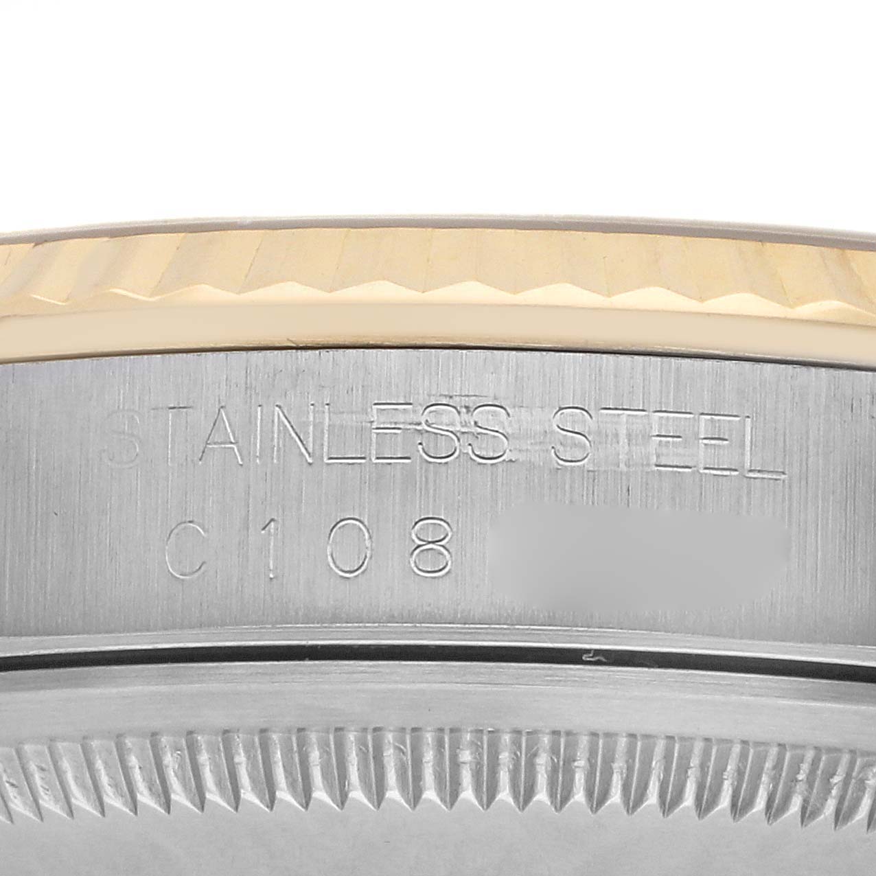 The image shows a close-up of the side of a Rolex Datejust 16233 Men
s Steel and Gold (two tone) Champagne Dial 16233 Men
s Steel and Gold (two tone) Champagne Dial, displaying the stainless steel engraving and part of the bezel.
