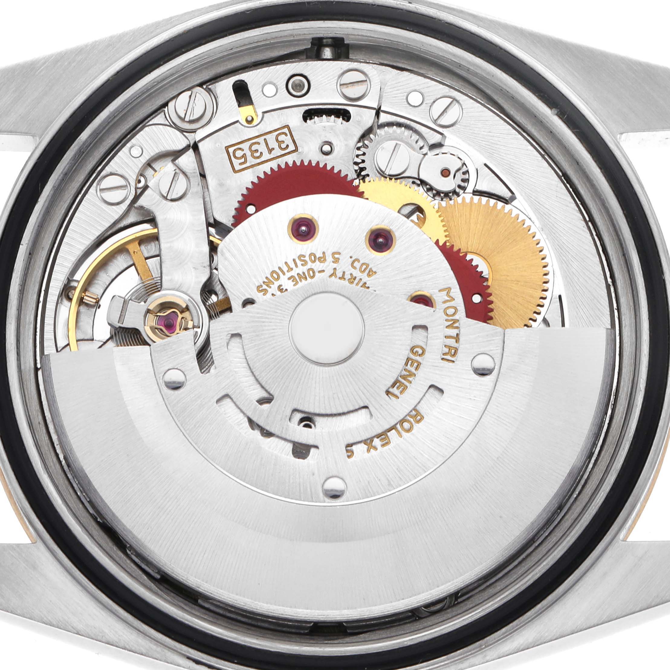 The image shows the movement of a Rolex Datejust 16233 Men
s Steel and Gold (two tone) Champagne Dial 16233 Men
s Steel and Gold (two tone) Champagne Dial, highlighting gears and mechanical components from the rear angle.