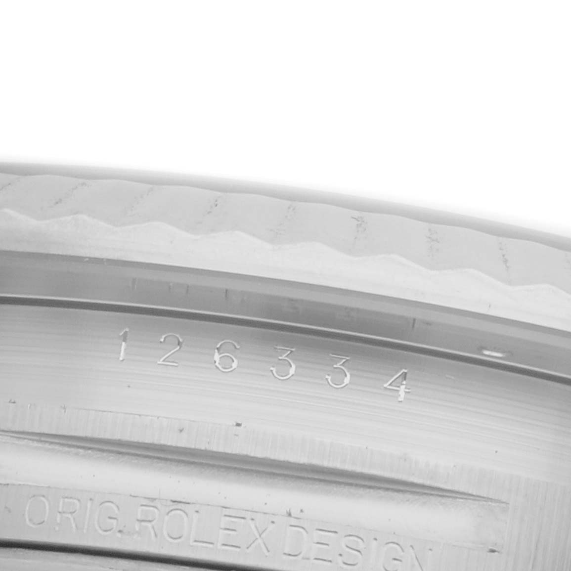 The image shows an angled view of the Rolex Datejust 41 126334 Men's Stainless Steel Grey Dial 126334 Men's Stainless Steel Grey Dial model's case edge with engraved specifications.