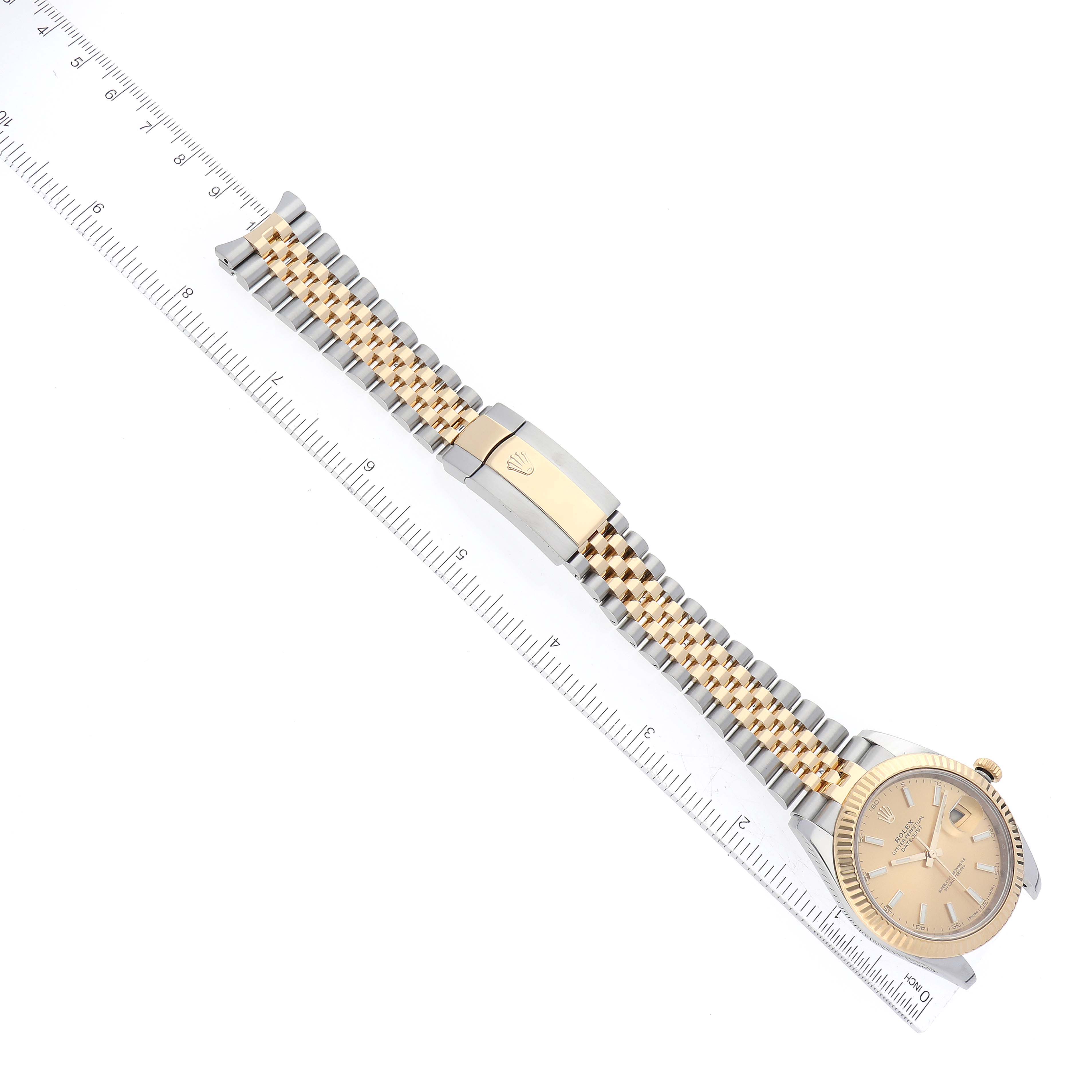 The image shows a top view of the Rolex Datejust 41 126333 Men's Steel and Gold (two tone) Champagne Dial 126333 Men's Steel and Gold (two tone) Champagne Dial watch, displaying its dial, bracelet, and clasp alongside a ruler.