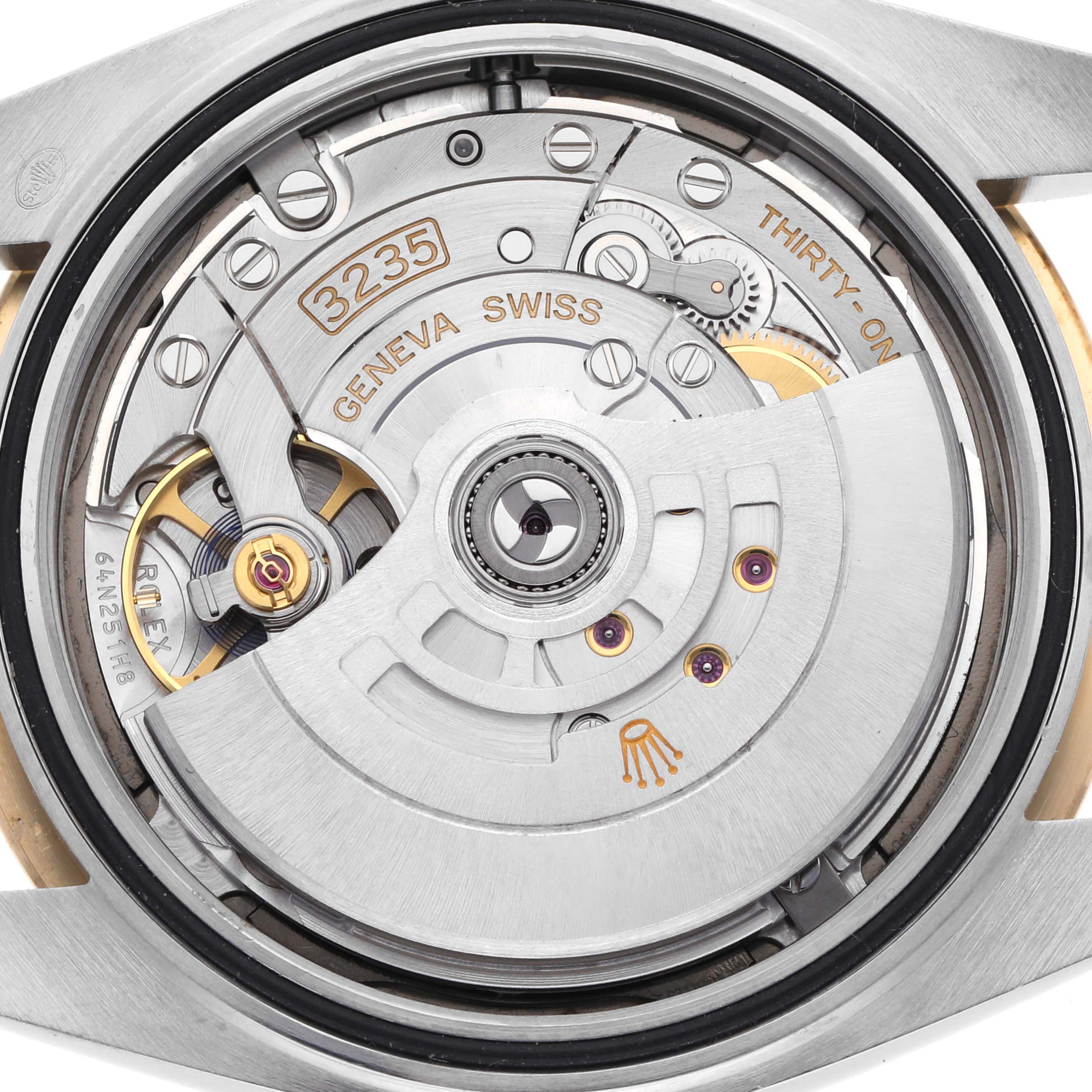 The image shows the movement of a Rolex Datejust 41 126333 Men's Steel and Gold (two tone) Grey Dial 126333 Men's Steel and Gold (two tone) Grey Dial, highlighting the rotor and internal components from a back angle.