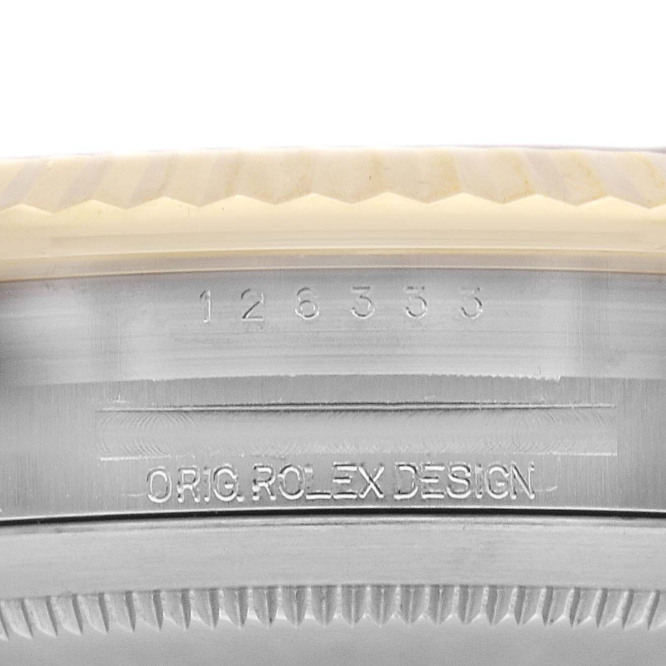 The image shows a close-up of the Rolex Datejust 41 126333 Men's Steel and Gold (two tone) Grey Dial 126333 Men's Steel and Gold (two tone) Grey Dial's case side with engravings and bezel edge.