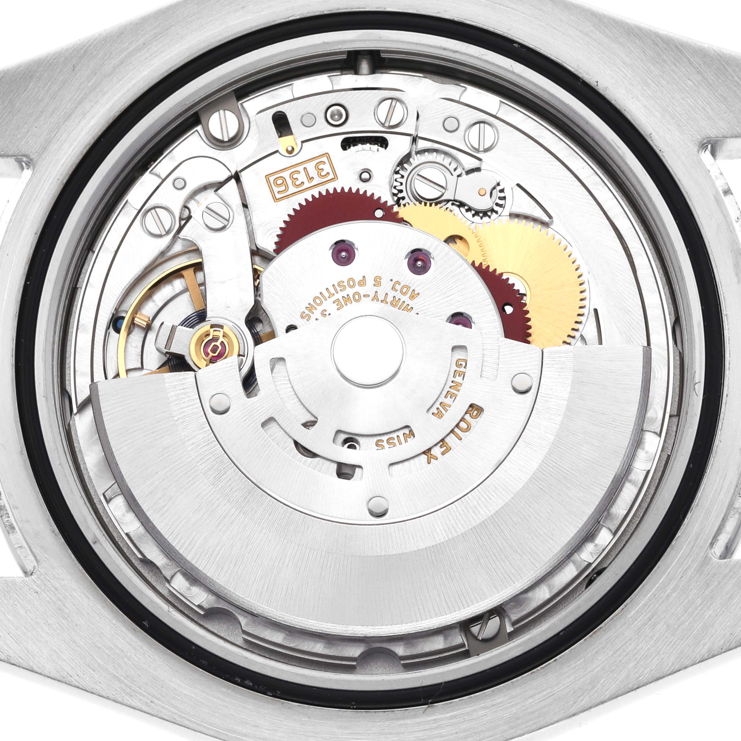 The image shows the movement of the Rolex Datejust 41 116300 Men's Stainless Steel Black Dial 116300 Men's Stainless Steel Black Dial, viewed from the back, revealing gears and mechanical components.