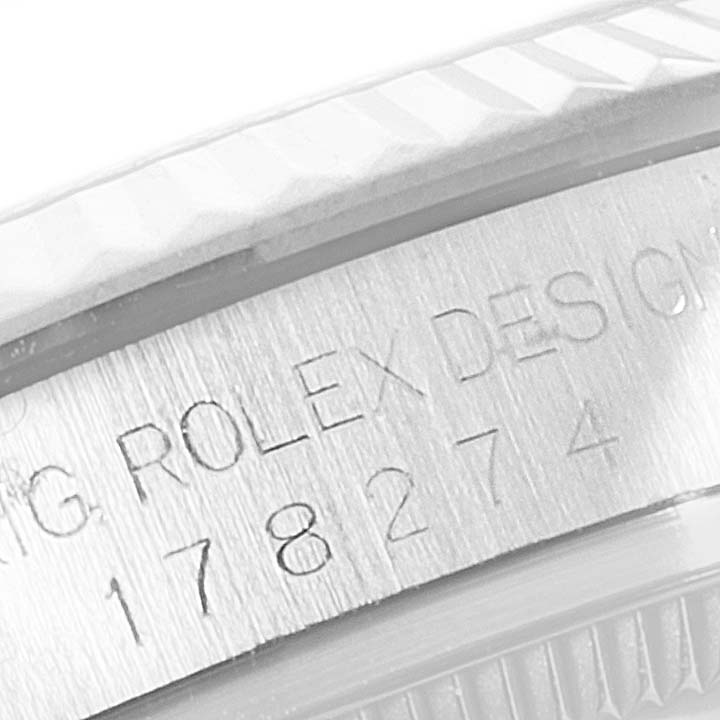 The image shows a close-up of the serial number and engraving on the side of a Mid-Size Rolex watch case.