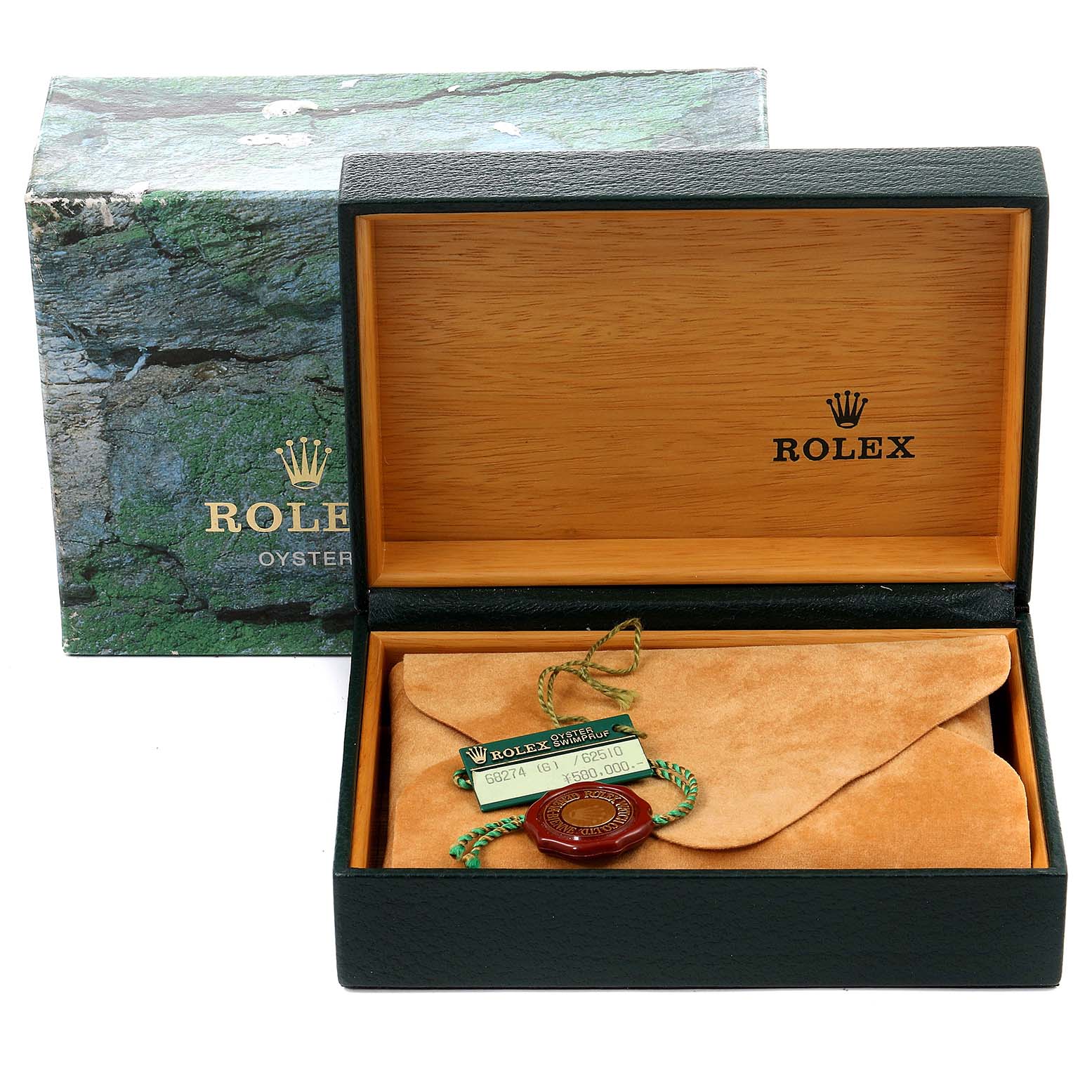 This image shows an open Rolex box with a tag and pouch for the Mid-Size model watch, with the exterior box in the background.