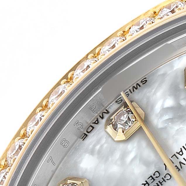 The image shows a close-up of the Rolex Mid-Size 178383 Women's Steel and Gold (two tone) Mother of Pearl Dial watch's bezel and partial dial with jeweled hour markers.