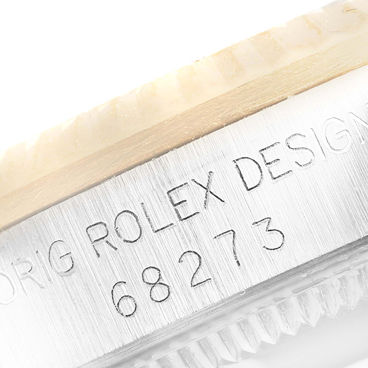 This image shows a close-up of the case side and bezel of a Mid-Size Rolex watch, highlighting the engraved serial number and "Rolex Design" text.