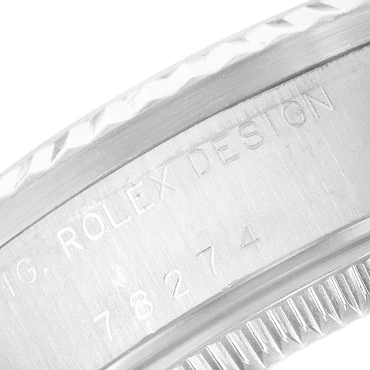 The image shows a close-up of the side of a Rolex Datejust 78274 Women's Stainless Steel Black Dial 78274 Women's Stainless Steel Black Dial watch case with engraved text.