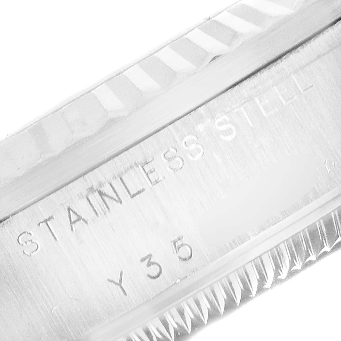 The image shows a close-up of the side casing and bezel of a Rolex Datejust 78274 Women's Stainless Steel Black Dial 78274 Women's Stainless Steel Black Dial watch, highlighting the "STAINLESS STEEL" engraving.