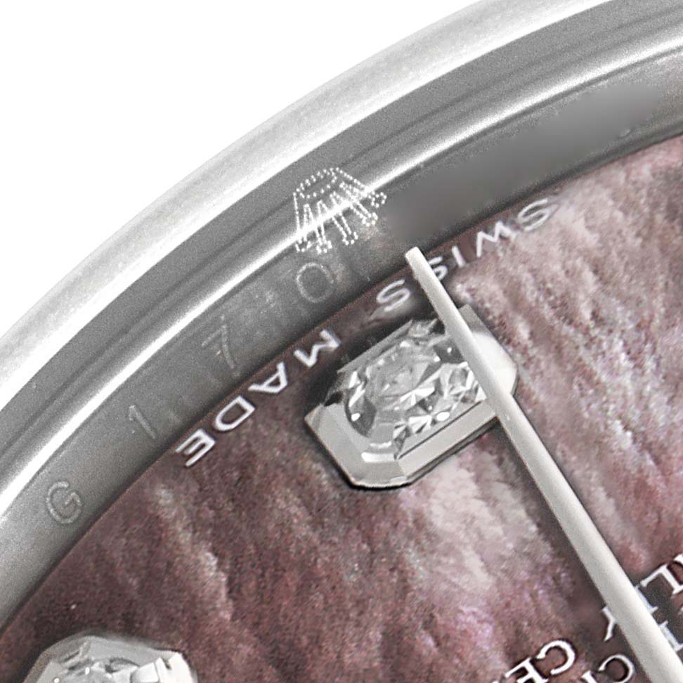The image shows a close-up of the Rolex Mid-Size 178274 Women's Stainless Steel Mother of Pearl Dial 178274 Women's Stainless Steel Mother of Pearl Dial watch dial, highlighting the bezel edge, diamond marker, and the "Swiss Made" inscription.