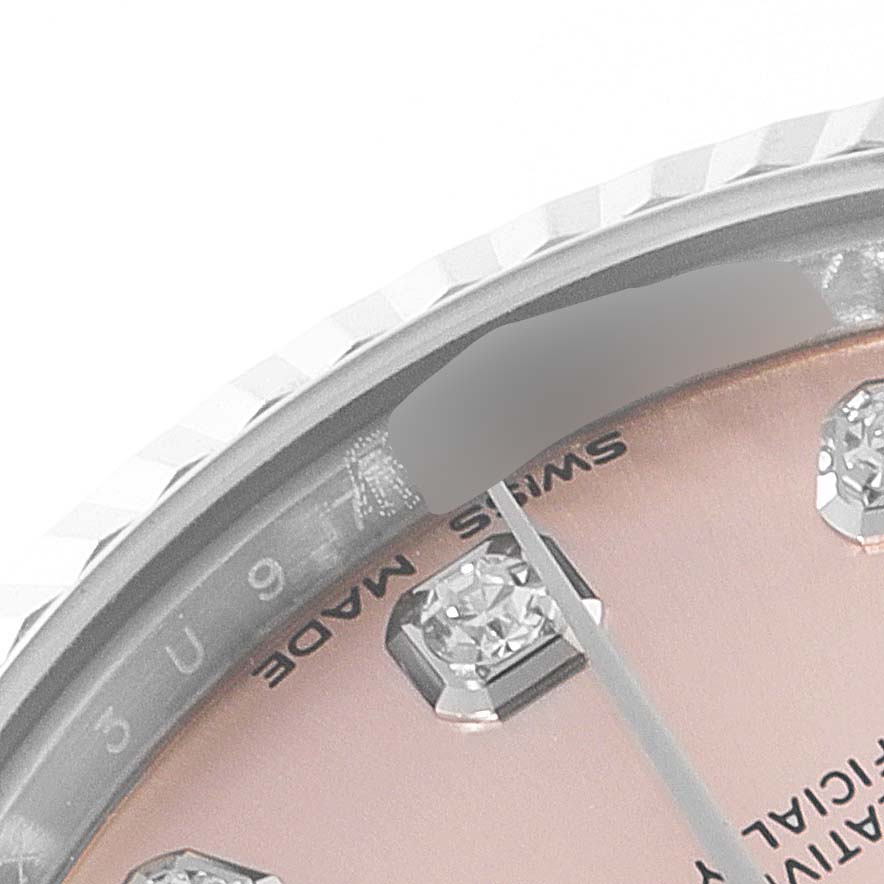 This image shows a close-up angle of a Rolex Mid-Size 178274 Women's Stainless Steel Pink Dial 178274 Women's Stainless Steel Pink Dial watch face, highlighting part of the dial with gem markers and the edge of the bezel.