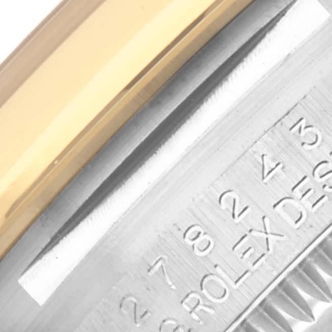 The image shows a close-up of the side of a Rolex Datejust 278243 Women's Steel and Gold (two tone) Silver Dial 278243 Women's Steel and Gold (two tone) Silver Dial, highlighting the bezel and part of the engraved edge.