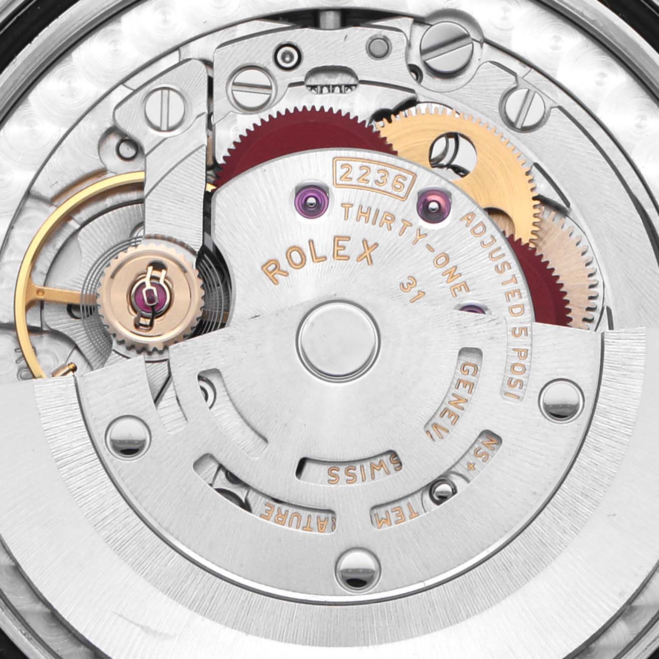 The image shows a close-up of the Rolex Datejust 278243 Women's Steel and Gold (two tone) Silver Dial 278243 Women's Steel and Gold (two tone) Silver Dial's movement, focusing on gears and engravings.