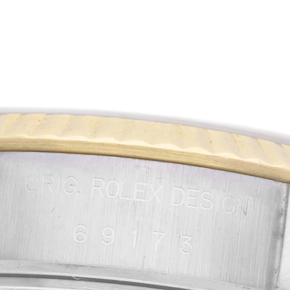 The image shows a close-up of the bezel and case side of a Rolex Datejust 69173 Women's Steel and Gold (two tone) Silver Dial 69173 Women's Steel and Gold (two tone) Silver Dial, highlighting its engraved details.