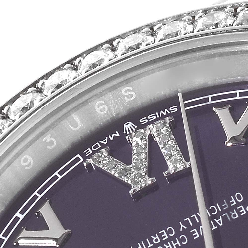 This image shows a close-up of the diamond-studded bezel and Roman numeral hour marker on a Rolex Datejust 126284RBR Men's Stainless Steel Purple Dial 126284RBR Men's Stainless Steel Purple Dial watch.
