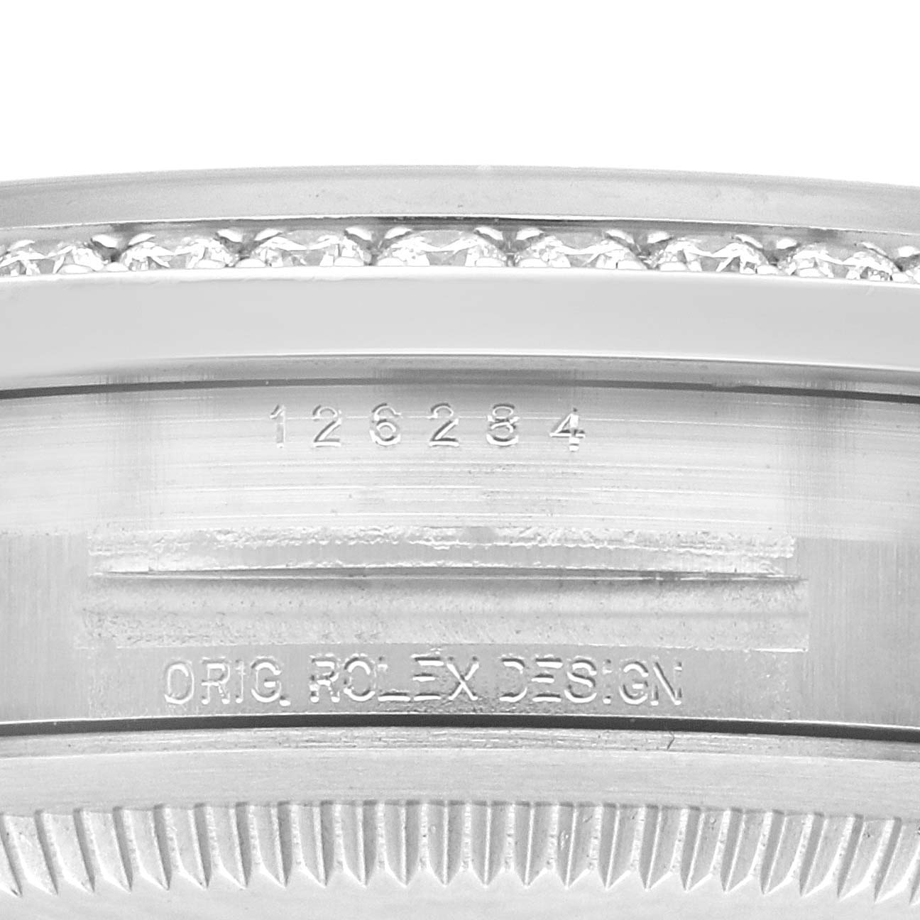 This close-up image of the Rolex Datejust 126284RBR Men's Stainless Steel Purple Dial 126284RBR Men's Stainless Steel Purple Dial watch shows the inner bezel with engraved serial number and "ORIG ROLEX DESIGN" text.