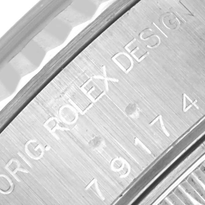 The image shows a close-up of the engraving on the case edge of a Rolex Datejust 79174NRD Women's Stainless Steel Mother of Pearl Dial 79174NRD Women's Stainless Steel Mother of Pearl Dial watch.