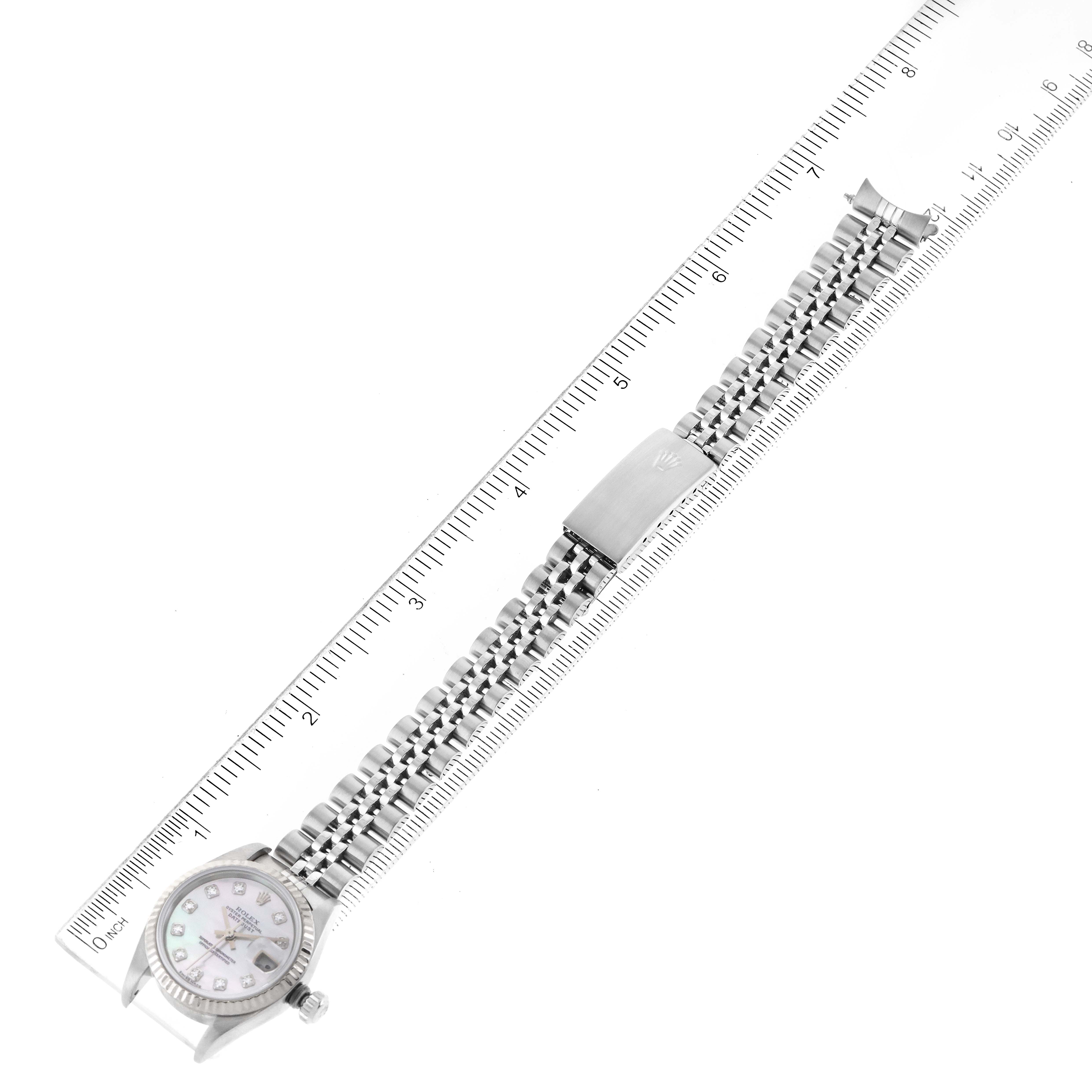The image shows a Rolex Datejust 79174 Women's Stainless Steel Mother of Pearl Dial 79174 Women's Stainless Steel Mother of Pearl Dial watch laid flat, with a focus on the bracelet and clasp, alongside a ruler for scale.