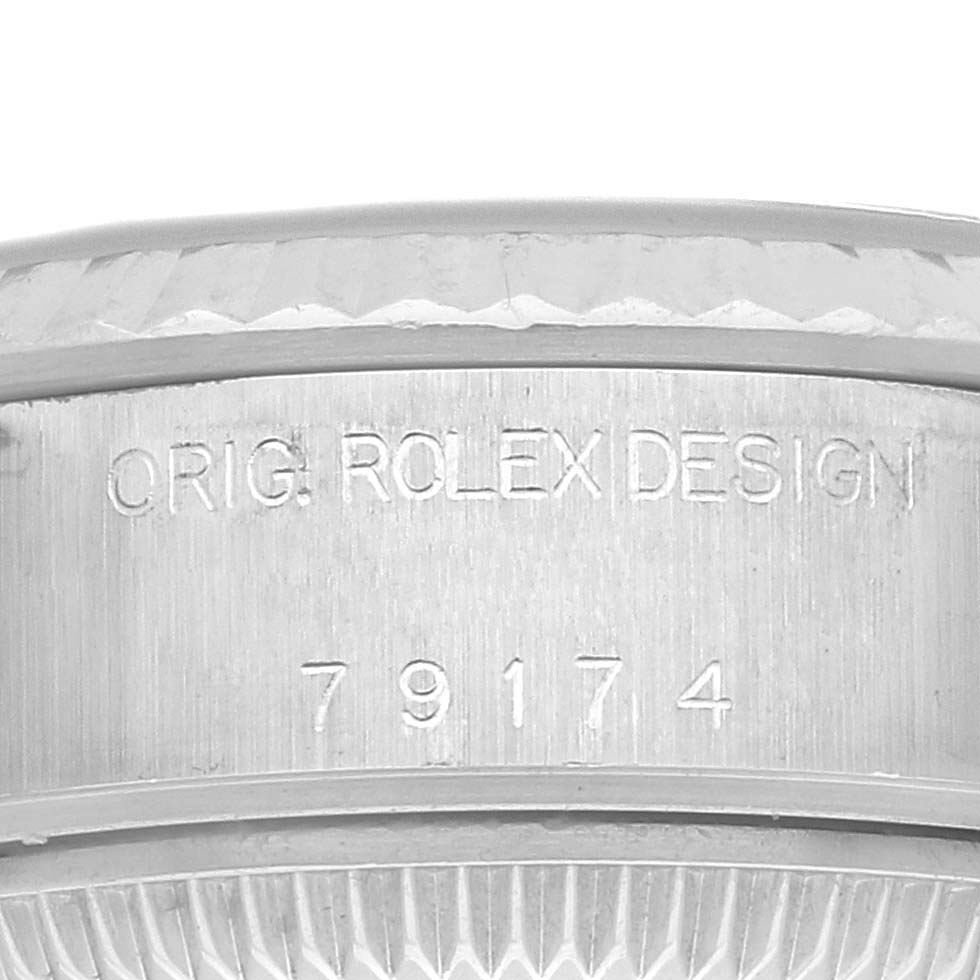 The image shows the side of the case for the Rolex Datejust 79174 Women's Stainless Steel Silver Dial 79174 Women's Stainless Steel Silver Dial, featuring the engraving "ORIG. ROLEX DESIGN" and model number "79174".