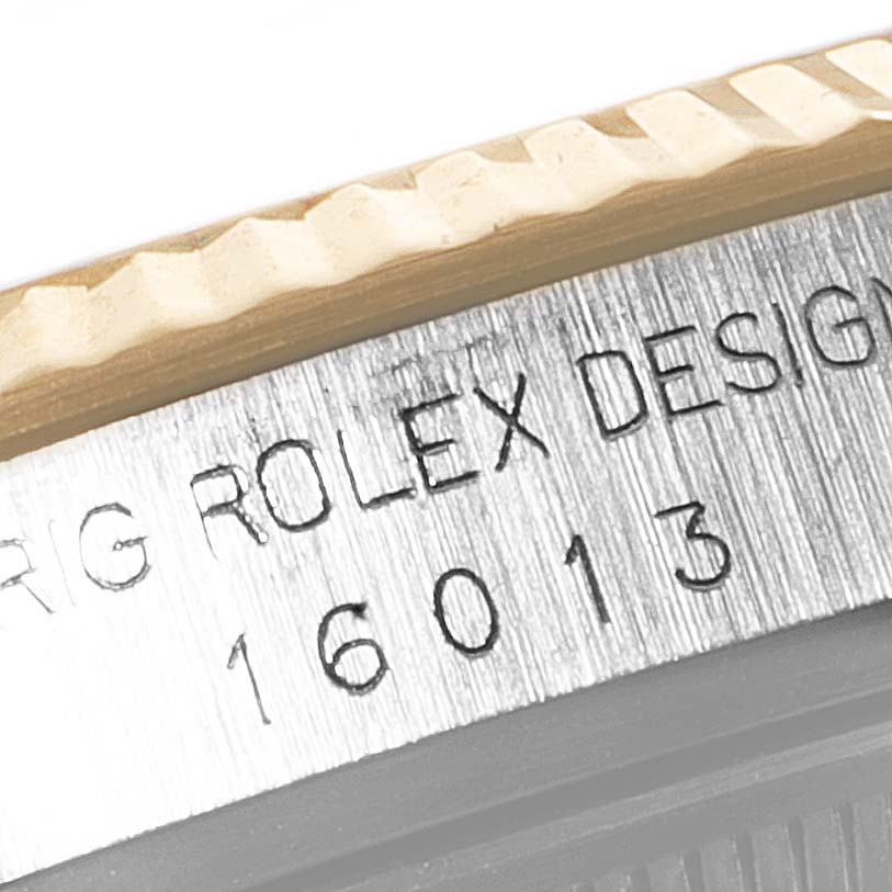 This close-up image shows the bezel and serial number engraving on a Rolex Vintage Collection 16013 Men's Steel and Gold (two tone) Champagne Dial 16013 Men's Steel and Gold (two tone) Champagne Dial model watch.