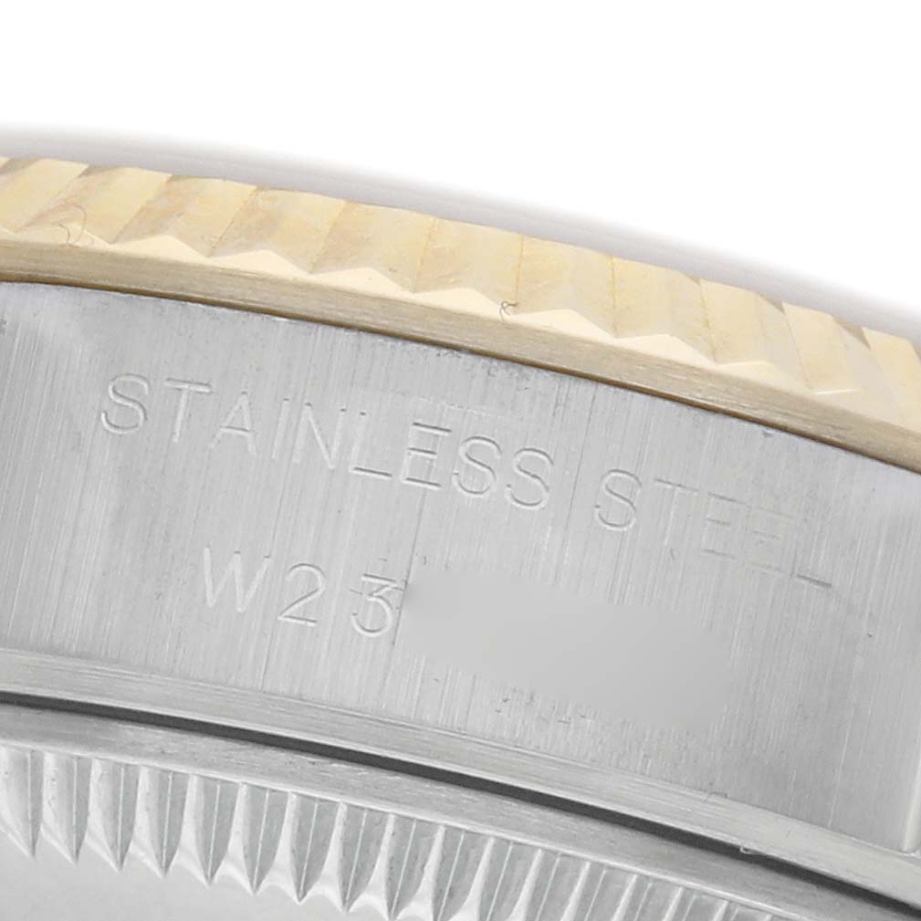 The image shows a close-up side angle of a Rolex Datejust 69173 Women's Steel and Gold (two tone) Champagne Dial 69173 Women's Steel and Gold (two tone) Champagne Dial, highlighting the fluted bezel and "Stainless Steel" engraving.