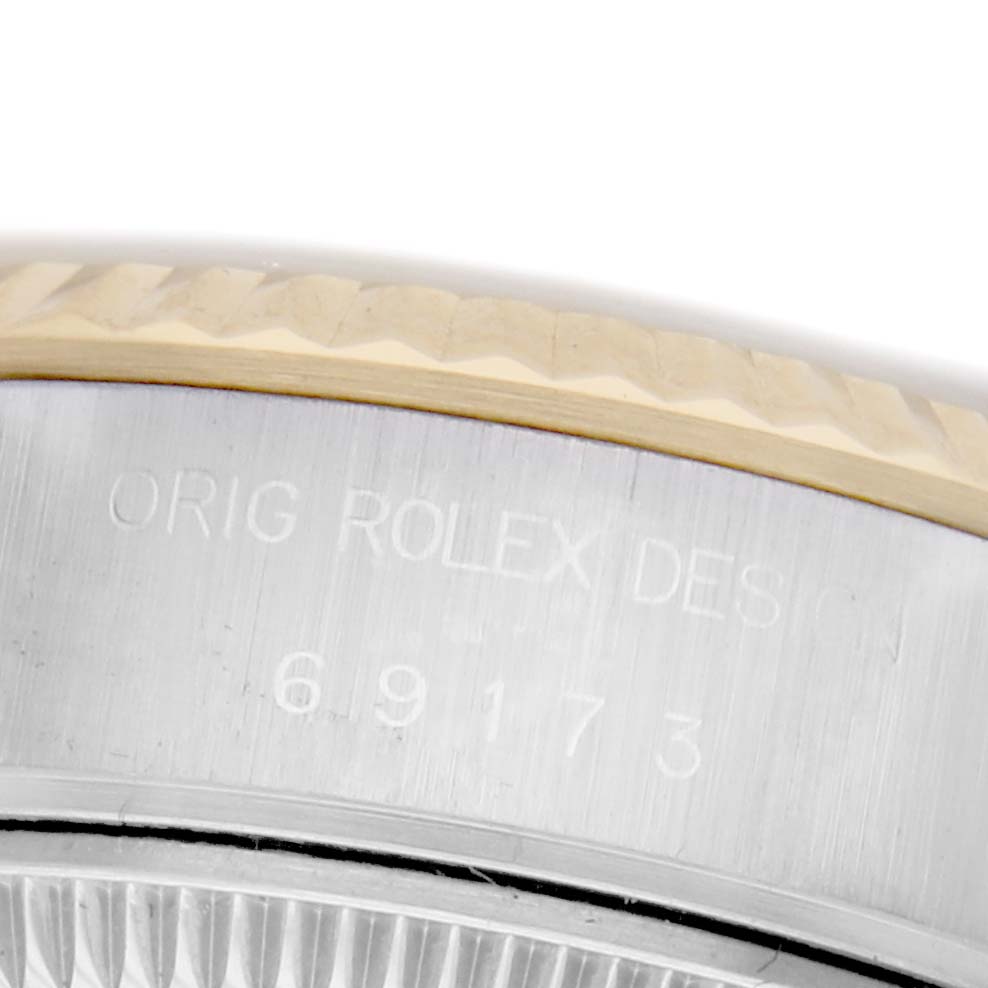 The image shows a close-up of the side of a Rolex Datejust 69173 Women's Steel and Gold (two tone) Champagne Dial 69173 Women's Steel and Gold (two tone) Champagne Dial, displaying the bezel and part of the engraved case with numbers.