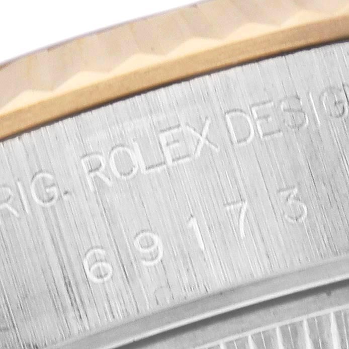 The image shows a close-up of the side of a Rolex Datejust 69173 Women's Steel and Gold (two tone) Champagne Dial 69173 Women's Steel and Gold (two tone) Champagne Dial watch, highlighting engraved details and the edge of the bezel.