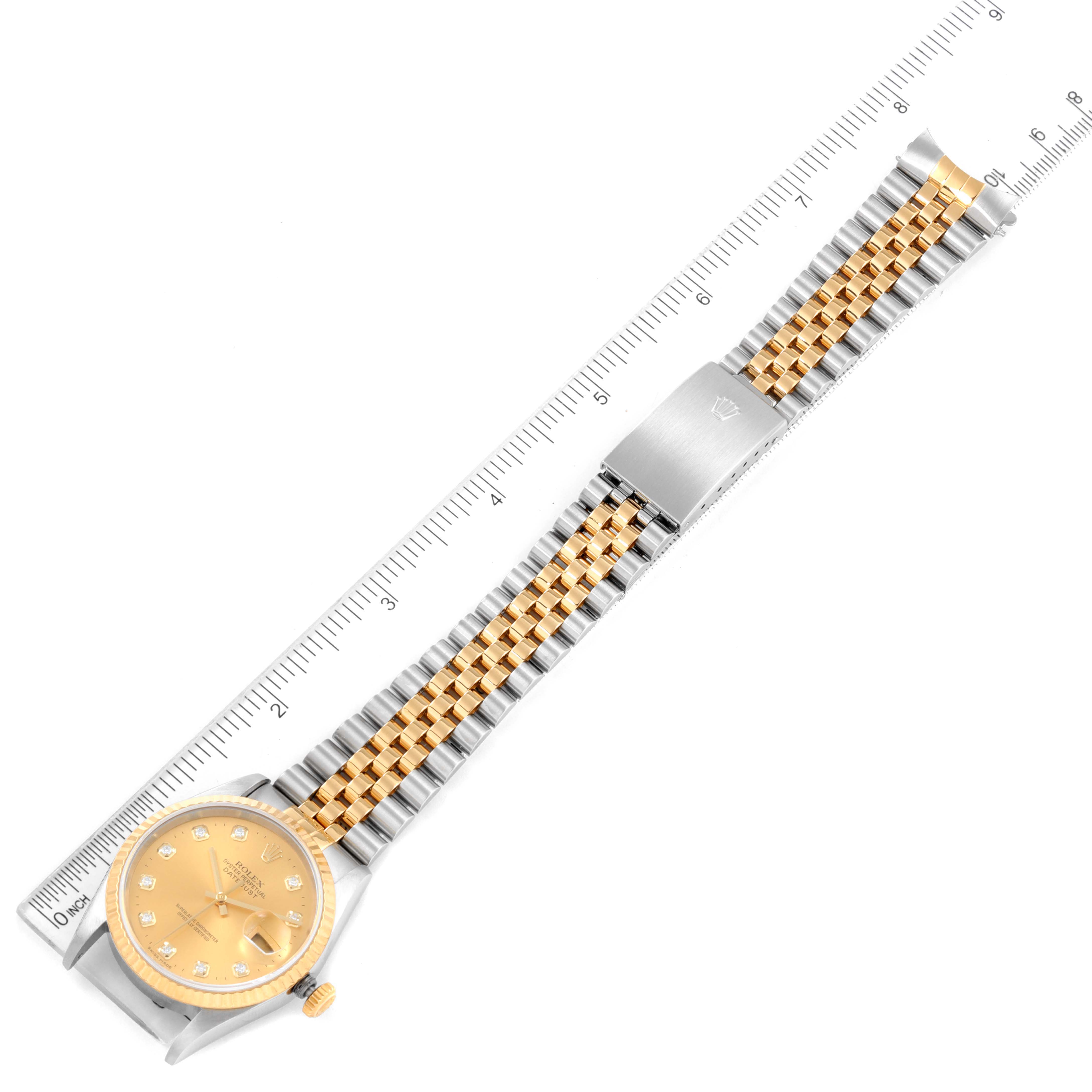 The image shows an overhead view of a Rolex Datejust 16233 Men's Steel and Gold (two tone) Champagne Dial 16233 Men's Steel and Gold (two tone) Champagne Dial watch with its gold dial, two-tone Jubilee bracelet, and clasp extended against a ruler.