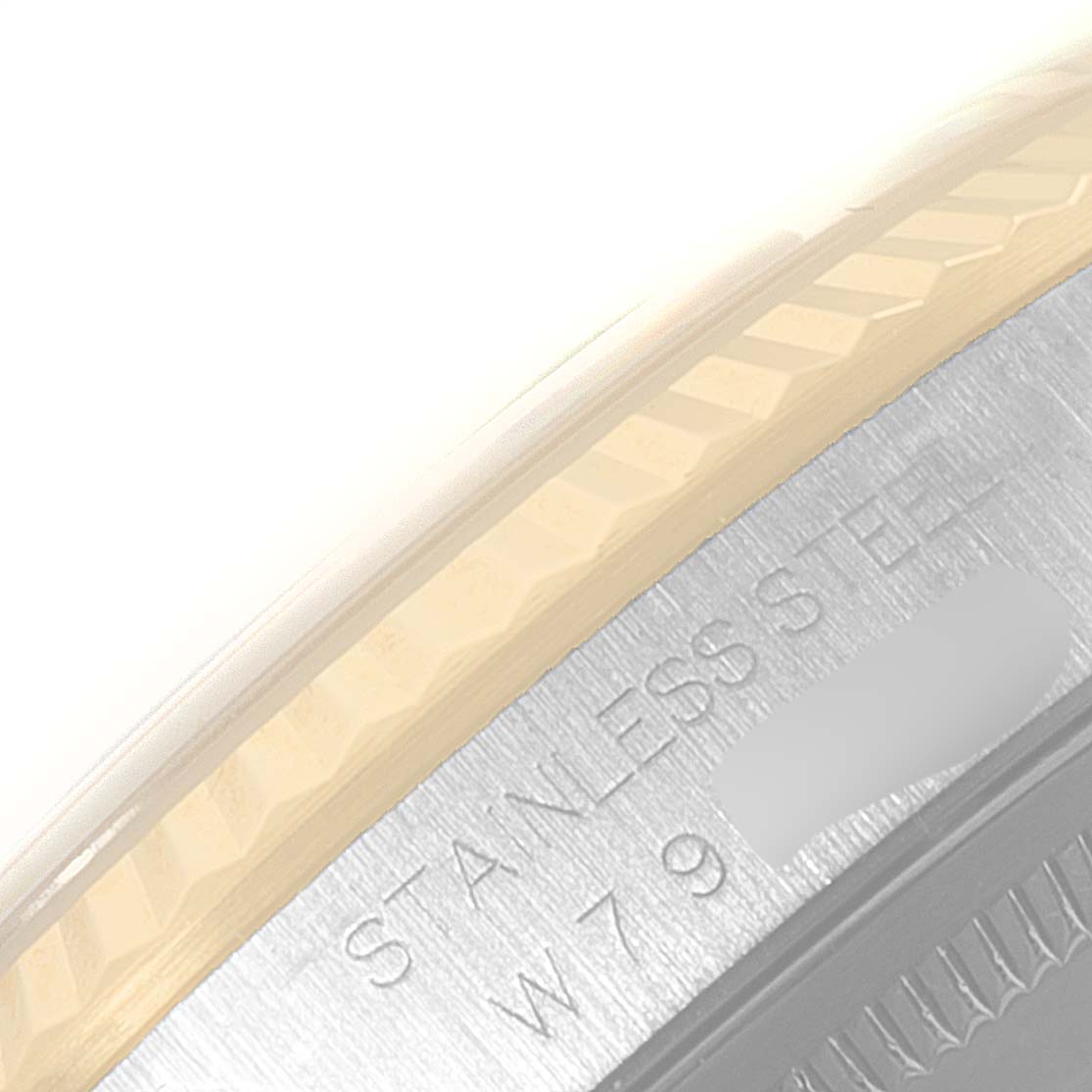 This close-up image shows the edge of the case back and the fluted bezel of a Rolex Datejust 16233 Men's Steel and Gold (two tone) Champagne Dial 16233 Men's Steel and Gold (two tone) Champagne Dial watch.