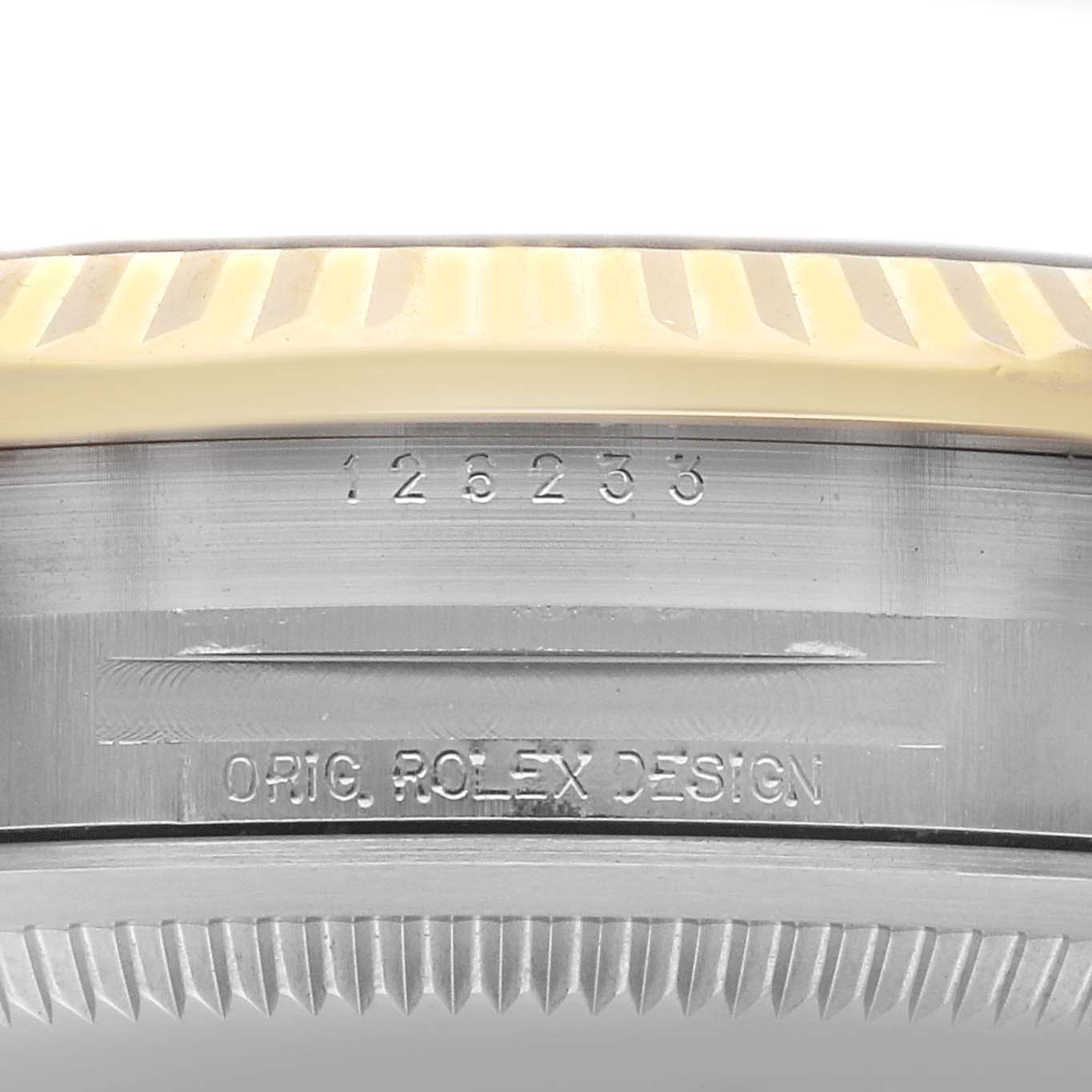 The image shows a close-up of the side of a Rolex Datejust 126233 Men's Steel and Gold (two tone) Champagne Dial 126233 Men's Steel and Gold (two tone) Champagne Dial, highlighting the case and bezel engravings.