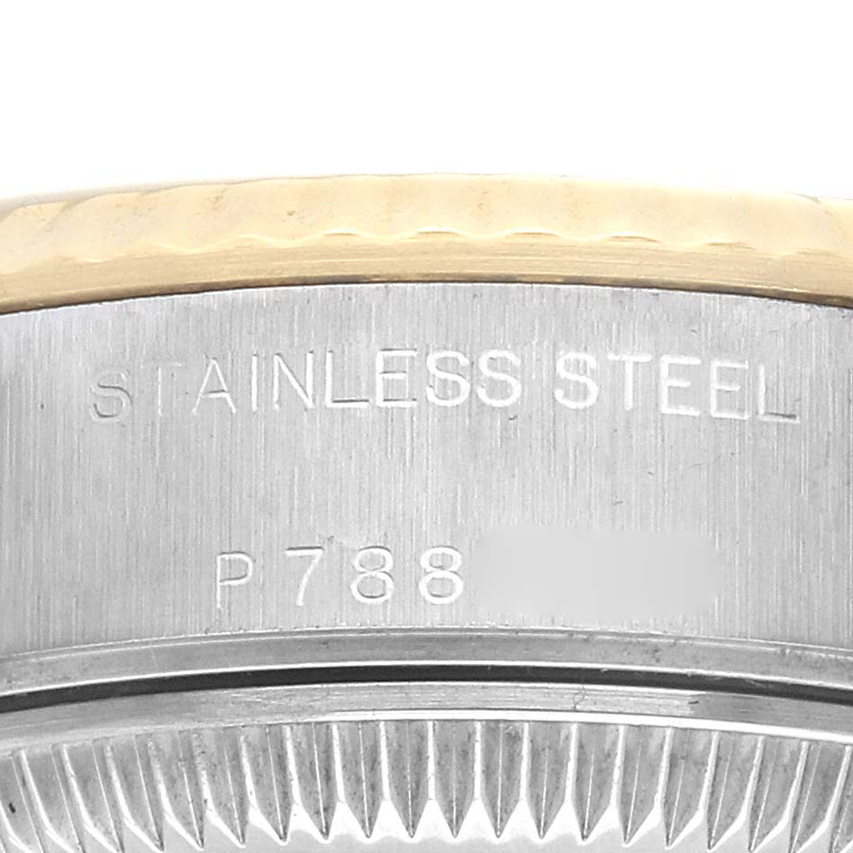 The image shows a close-up of the side of a Rolex Datejust 79173 Women's Steel and Gold (two tone) Champagne Dial 79173 Women's Steel and Gold (two tone) Champagne Dial watch, highlighting the stainless steel material and some engraved numbers.