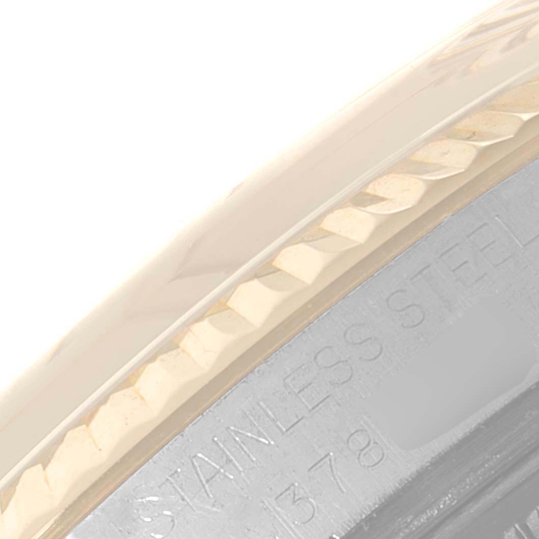 This close-up image shows part of the bezel and case back of the Rolex Vintage Collection 1601 Men's Steel and Gold (two tone) Silver Dial 1601 Men's Steel and Gold (two tone) Silver Dial model watch.