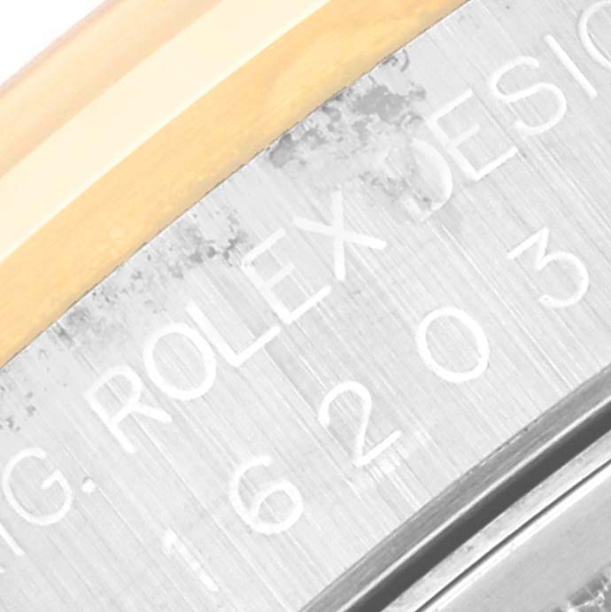 This close-up image shows the engraved model number and part of the bezel of a Rolex Datejust 16203 Men's Steel and Gold (two tone) Grey Dial 16203 Men's Steel and Gold (two tone) Grey Dial watch.