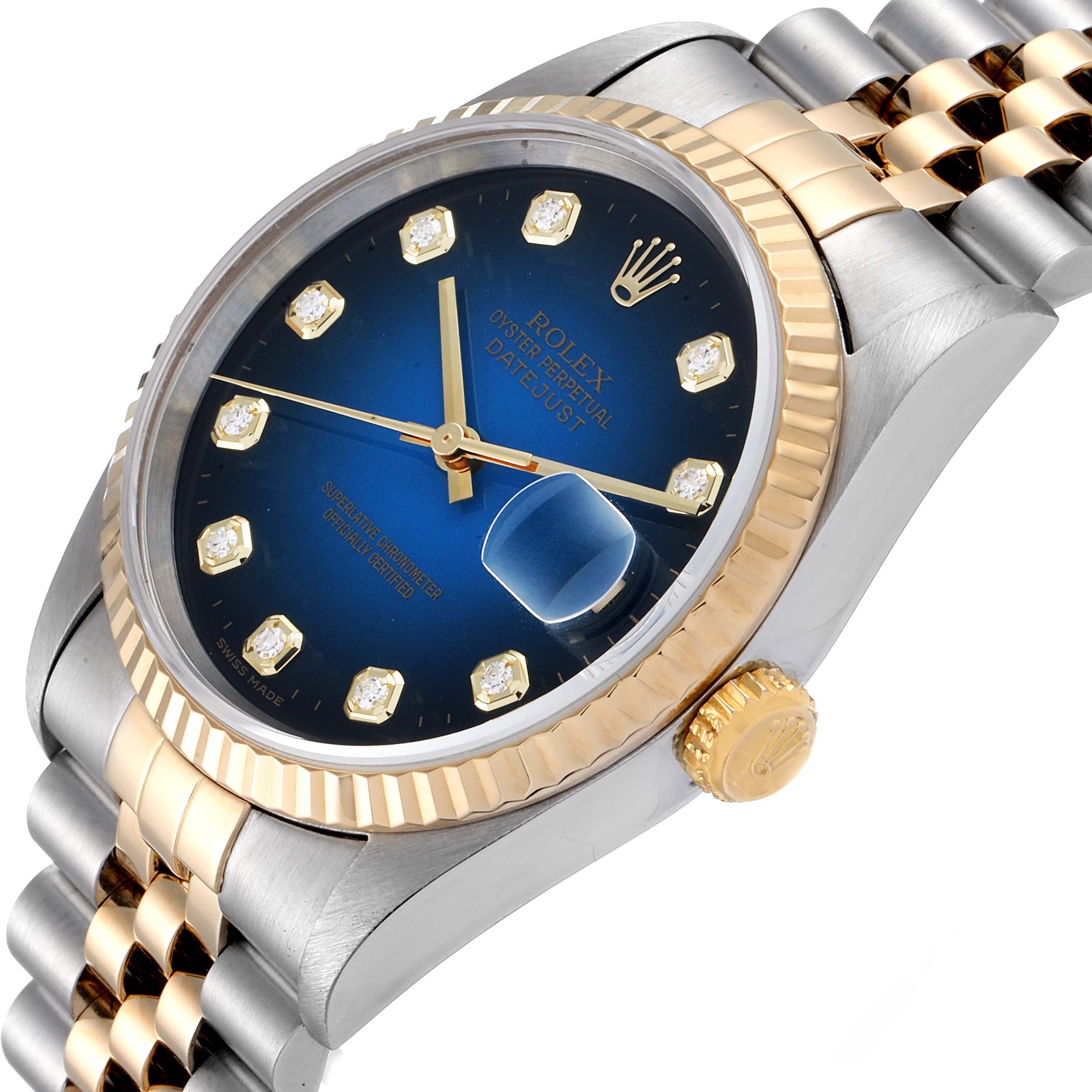 The image shows a Rolex Datejust 16233 Men's Steel and Gold (two tone) Blue Dial 16233 Men's Steel and Gold (two tone) Blue Dial model watch at an oblique angle, highlighting its blue dial, gold bezel, and two-tone bracelet.