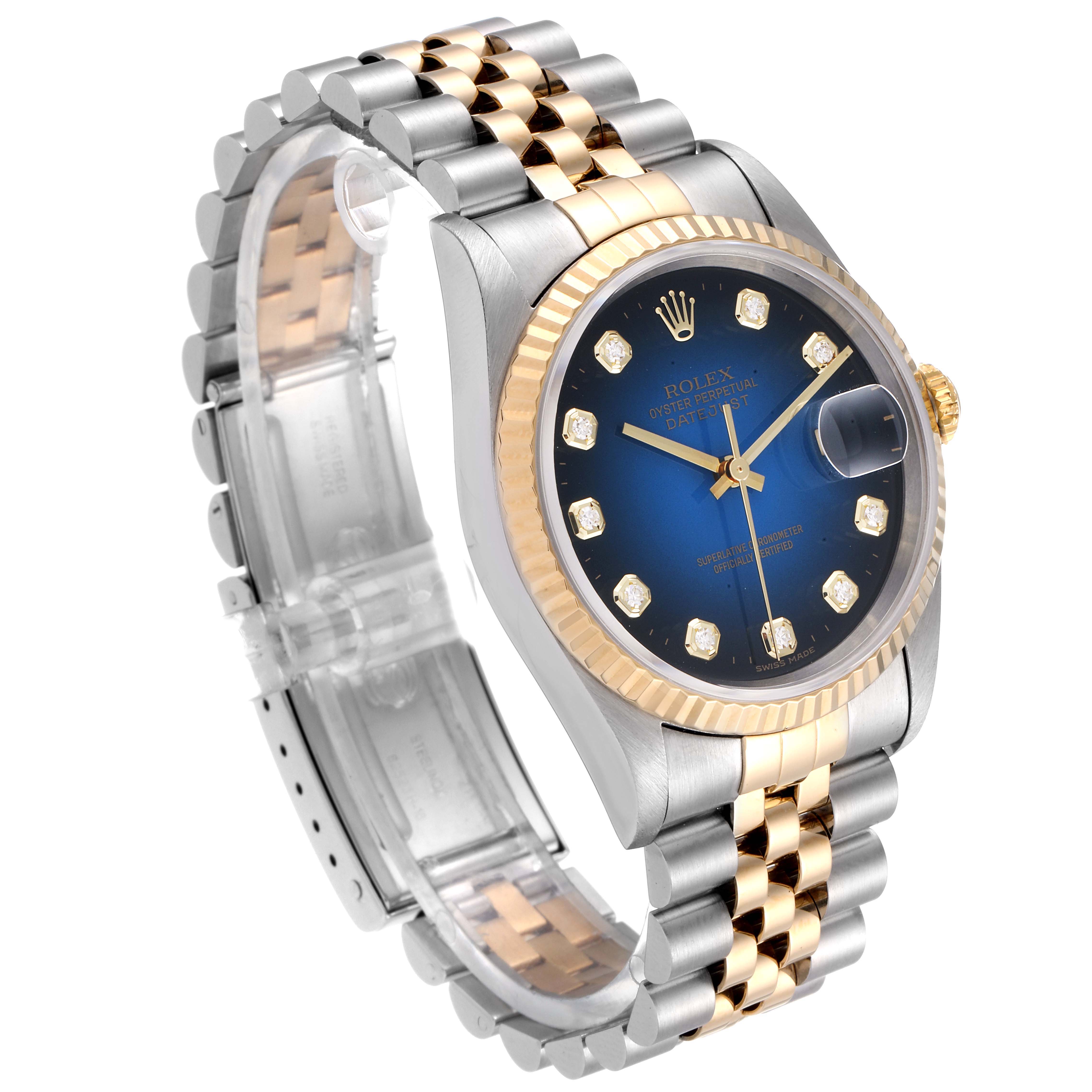 This image shows a Rolex Datejust 16233 Men's Steel and Gold (two tone) Blue Dial 16233 Men's Steel and Gold (two tone) Blue Dial watch at a 3/4 angle, highlighting the bracelet, case, dial, and fluted bezel.