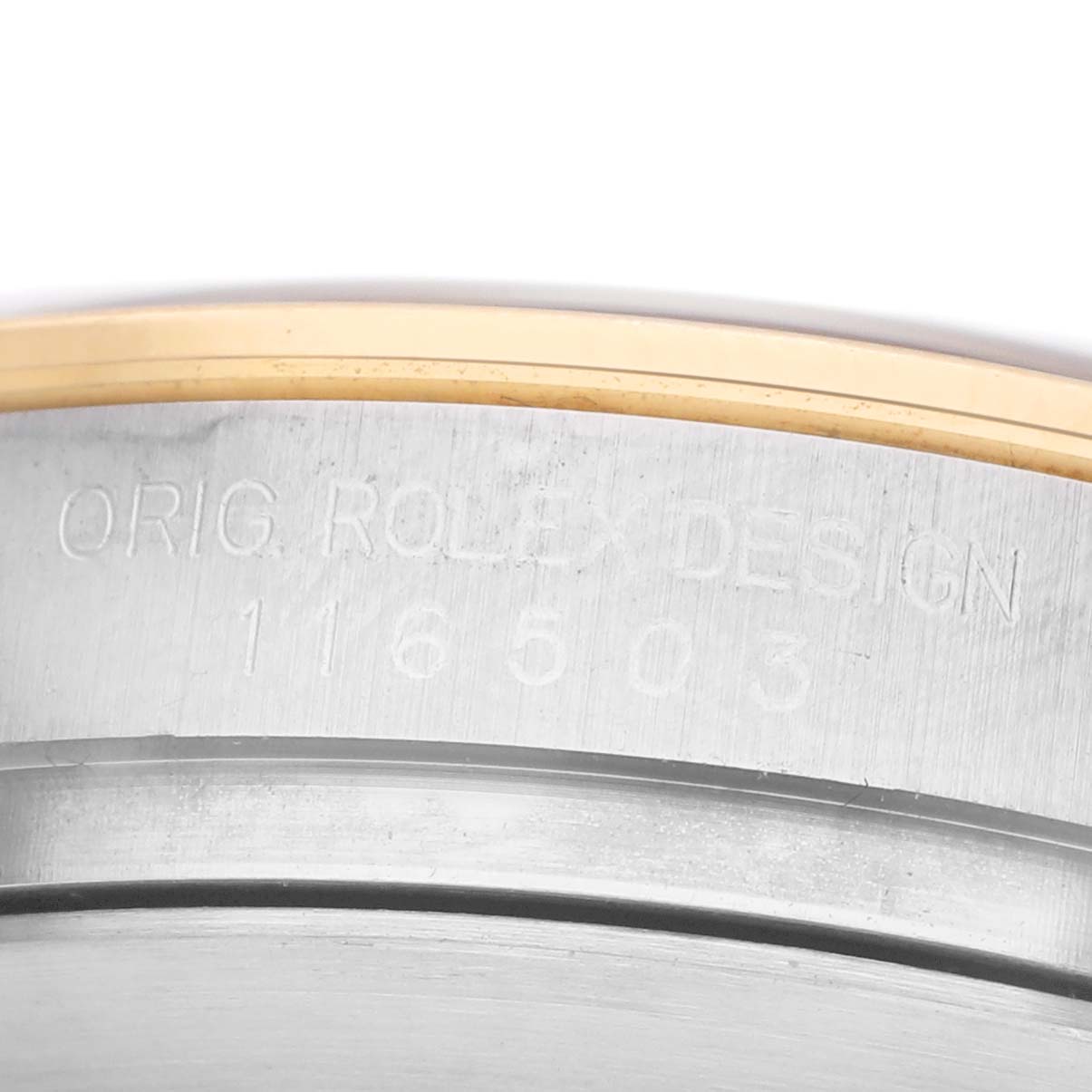 The image shows a close-up of the side engraving on the case of a Rolex Daytona 116503 Men's Steel and Gold (two tone) Black Dial watch.