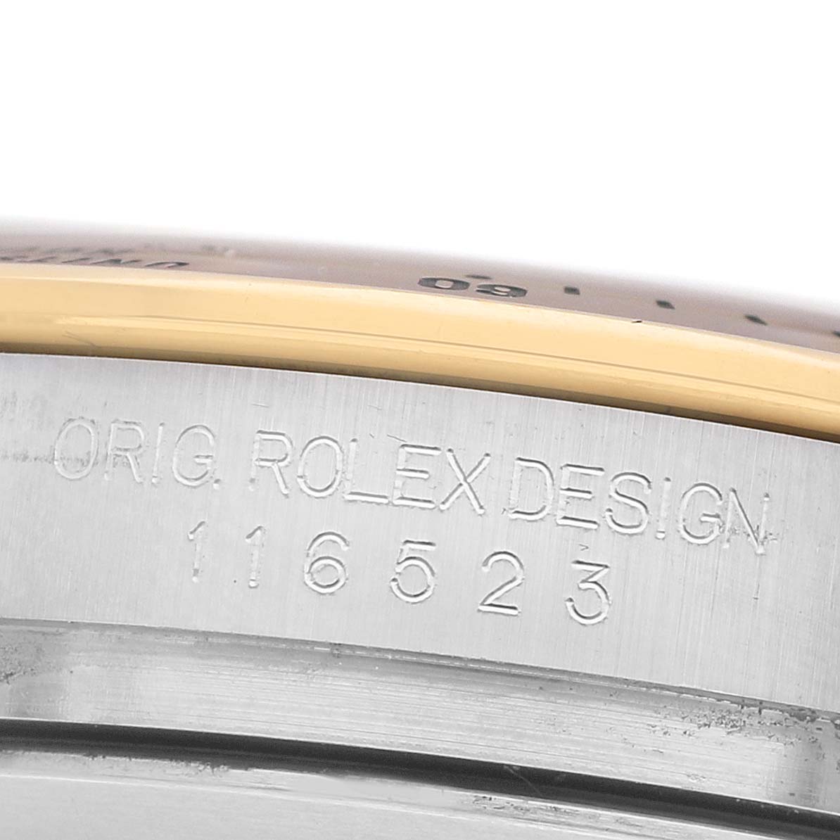 The image shows the side of a Rolex Daytona 116523 Men's Steel and Gold (two tone) Silver Dial watch, highlighting the engraved "ORIG. ROLEX DESIGN" and model number.