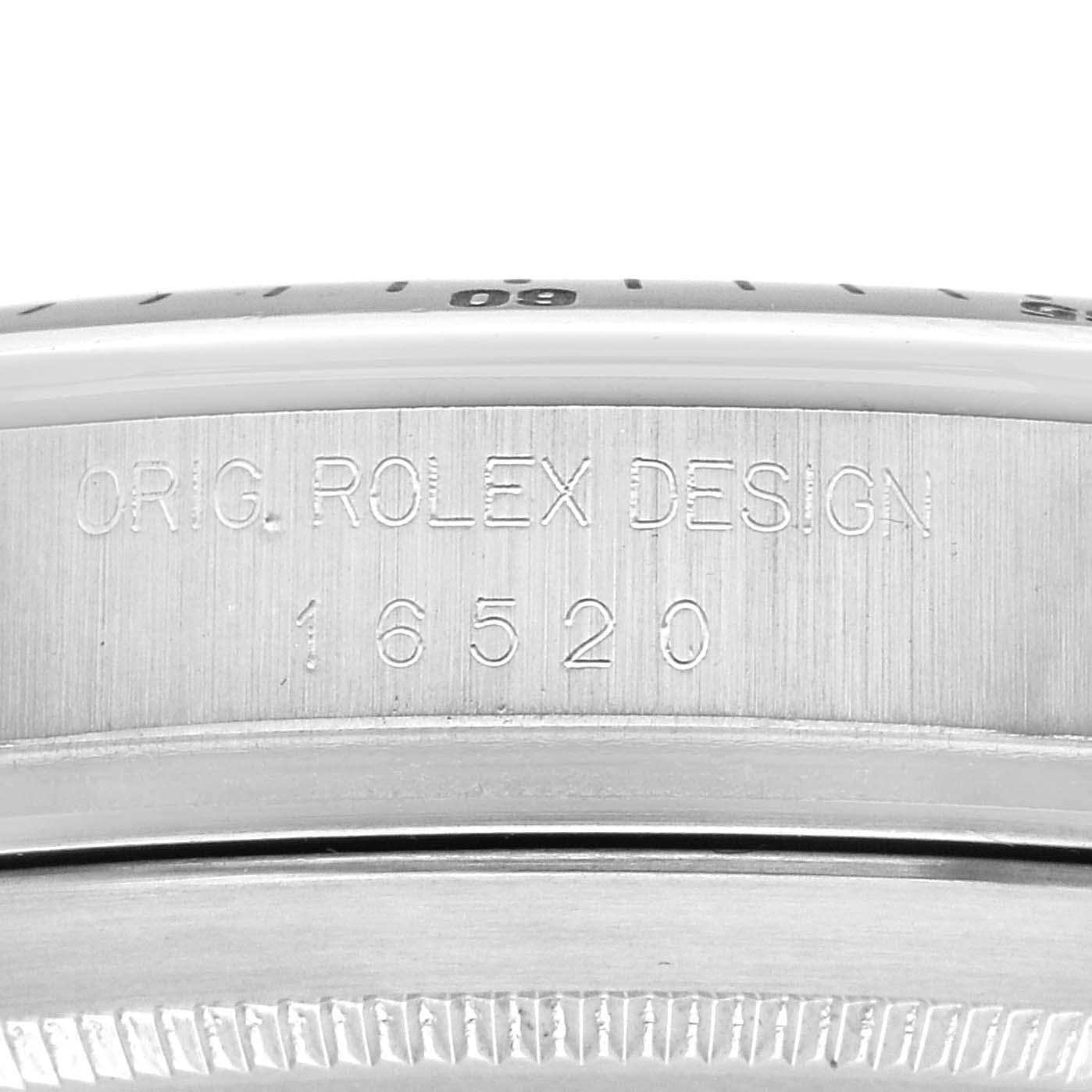 The image shows a close-up of the case side of a Rolex Daytona 16520 Men's Stainless Steel Black Dial, featuring engraved model details.